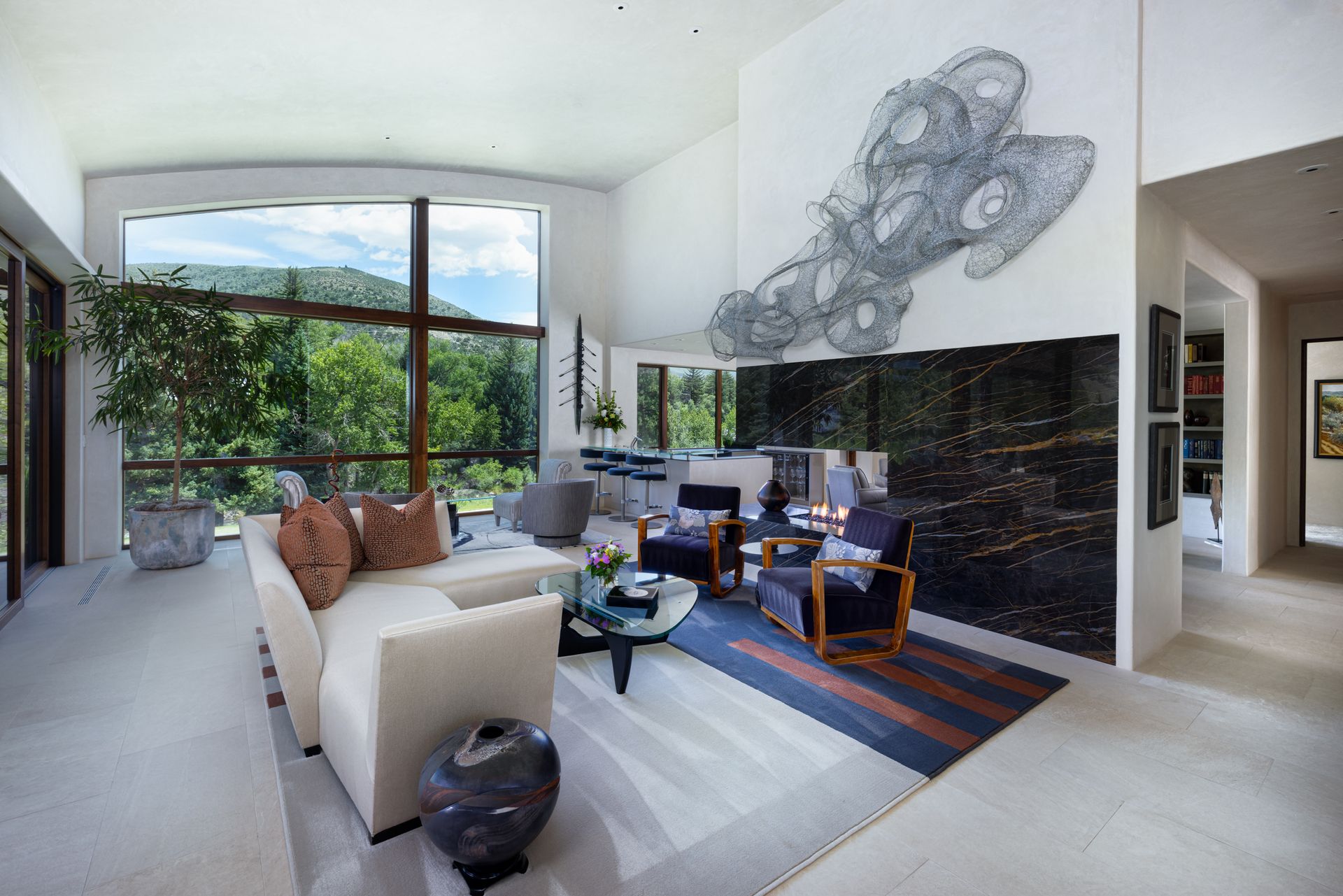 A living room with a couch , chairs and a fireplace