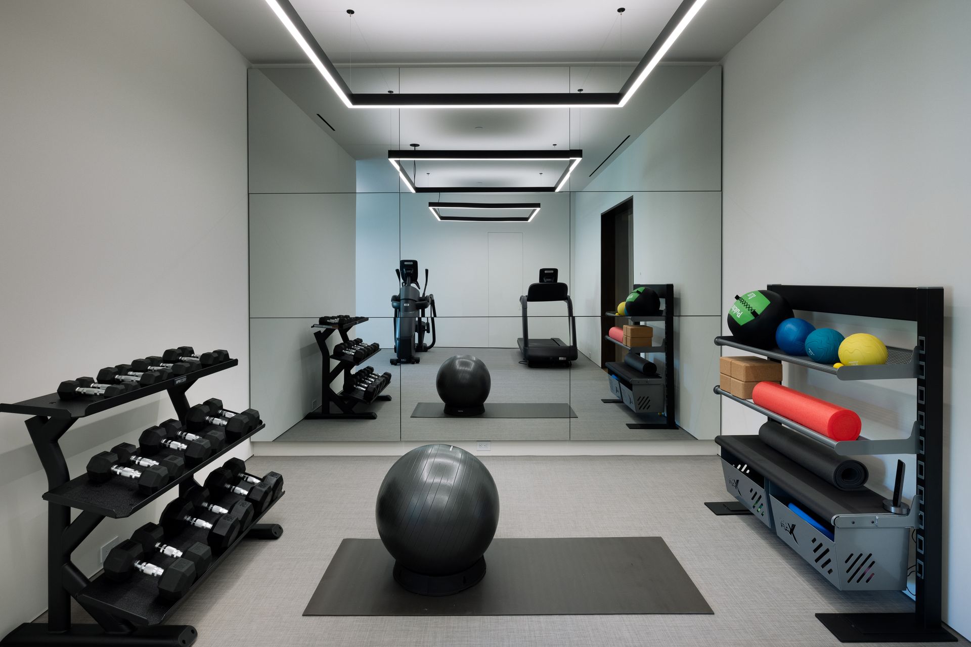 A gym filled with dumbbells and a ball with the number 10 on it