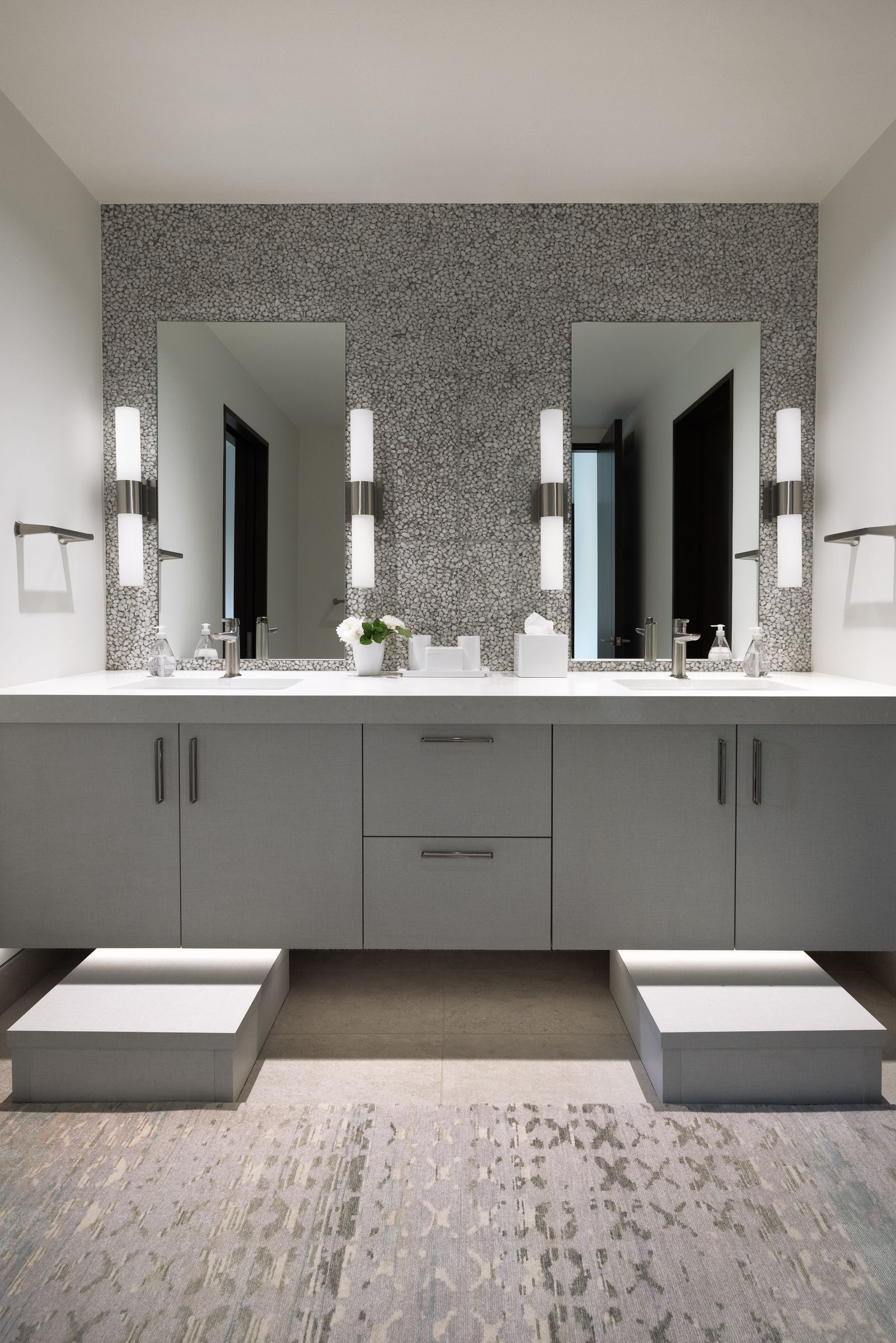 A bathroom with two sinks and two mirrors.