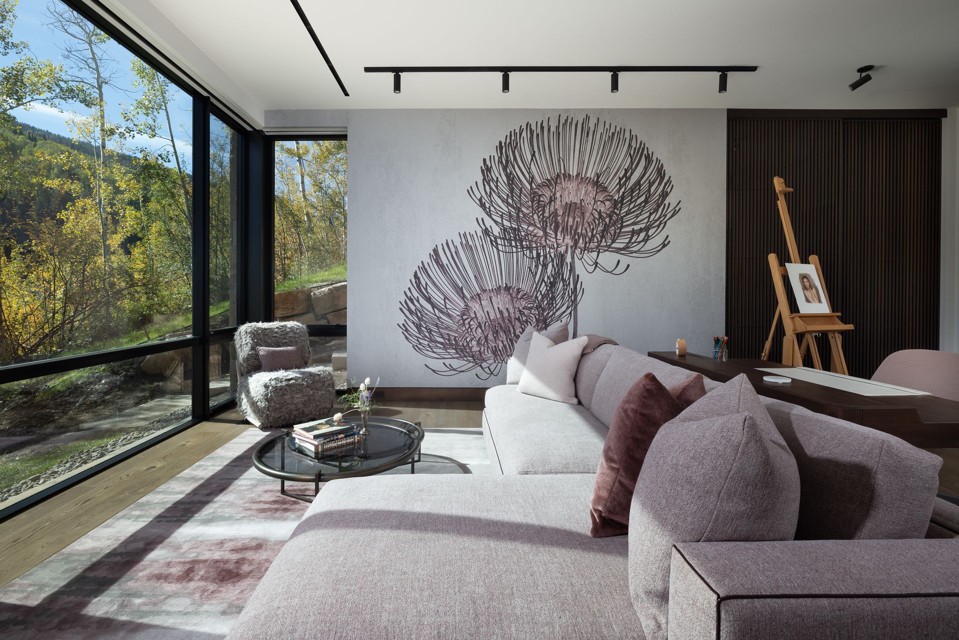 A living room with a couch and chairs and a large window