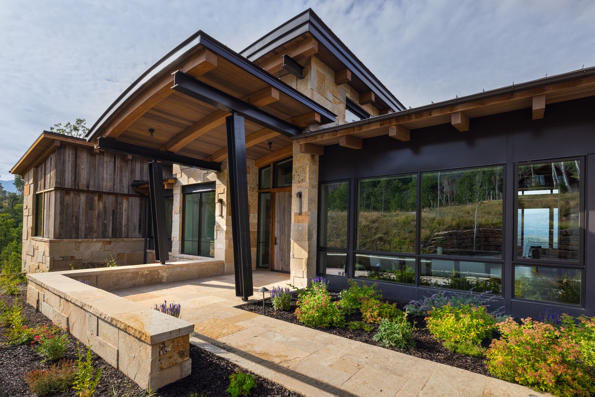 A large house with a lot of windows and a wooden roof.