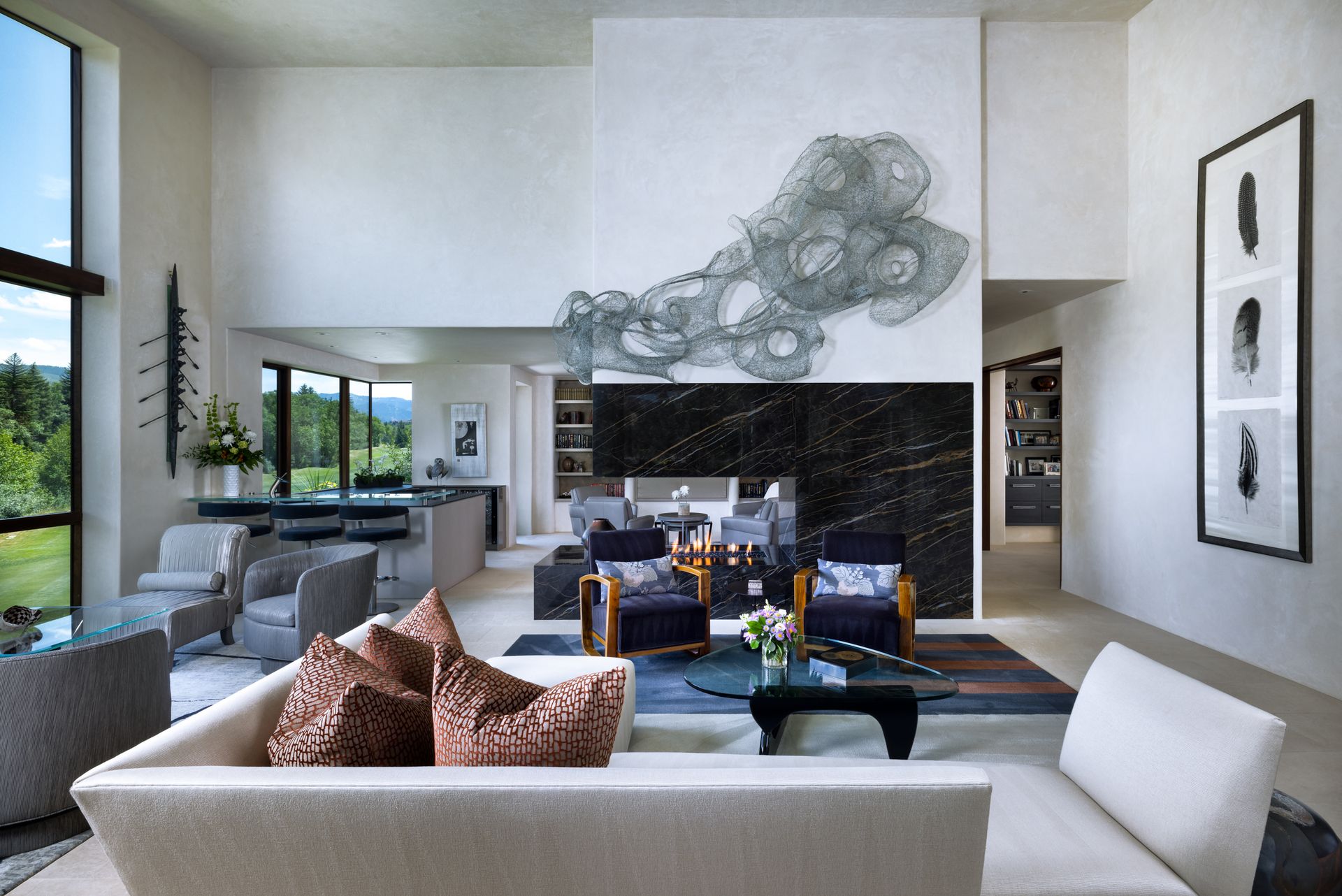 A living room with a couch and chairs and a fireplace