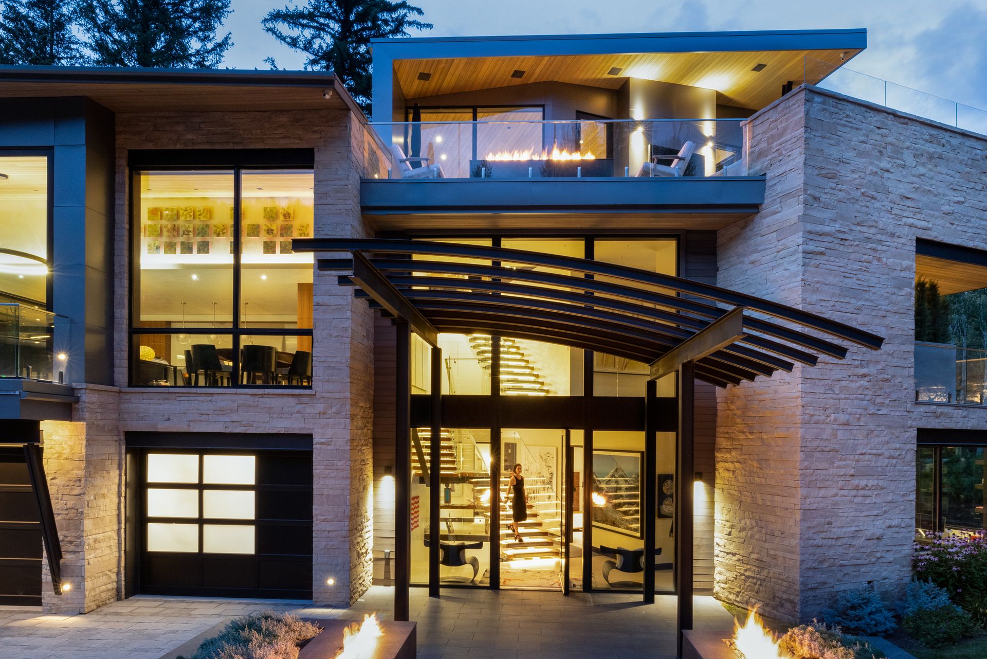 A large house with a fire pit in front of it