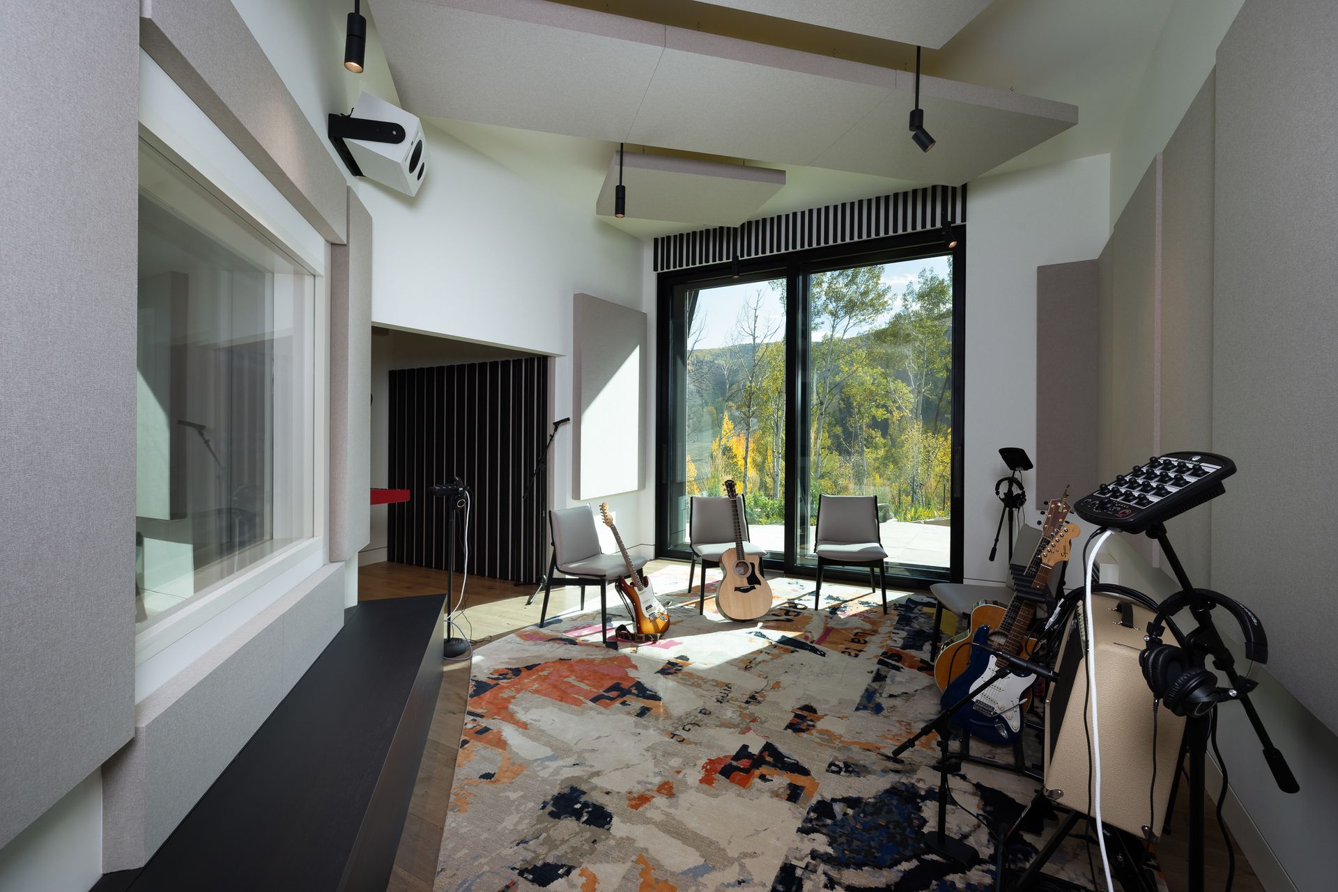 A room with a lot of guitars and drums in it