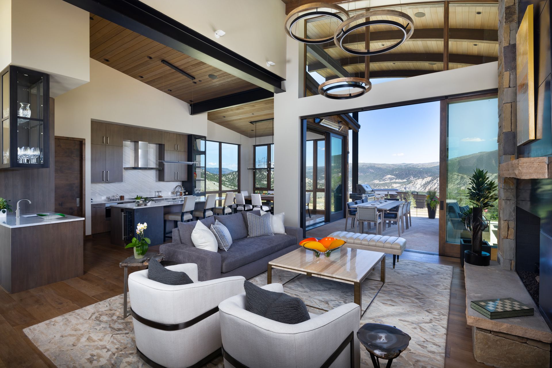 A living room with a couch , chairs , coffee table and sliding glass doors.