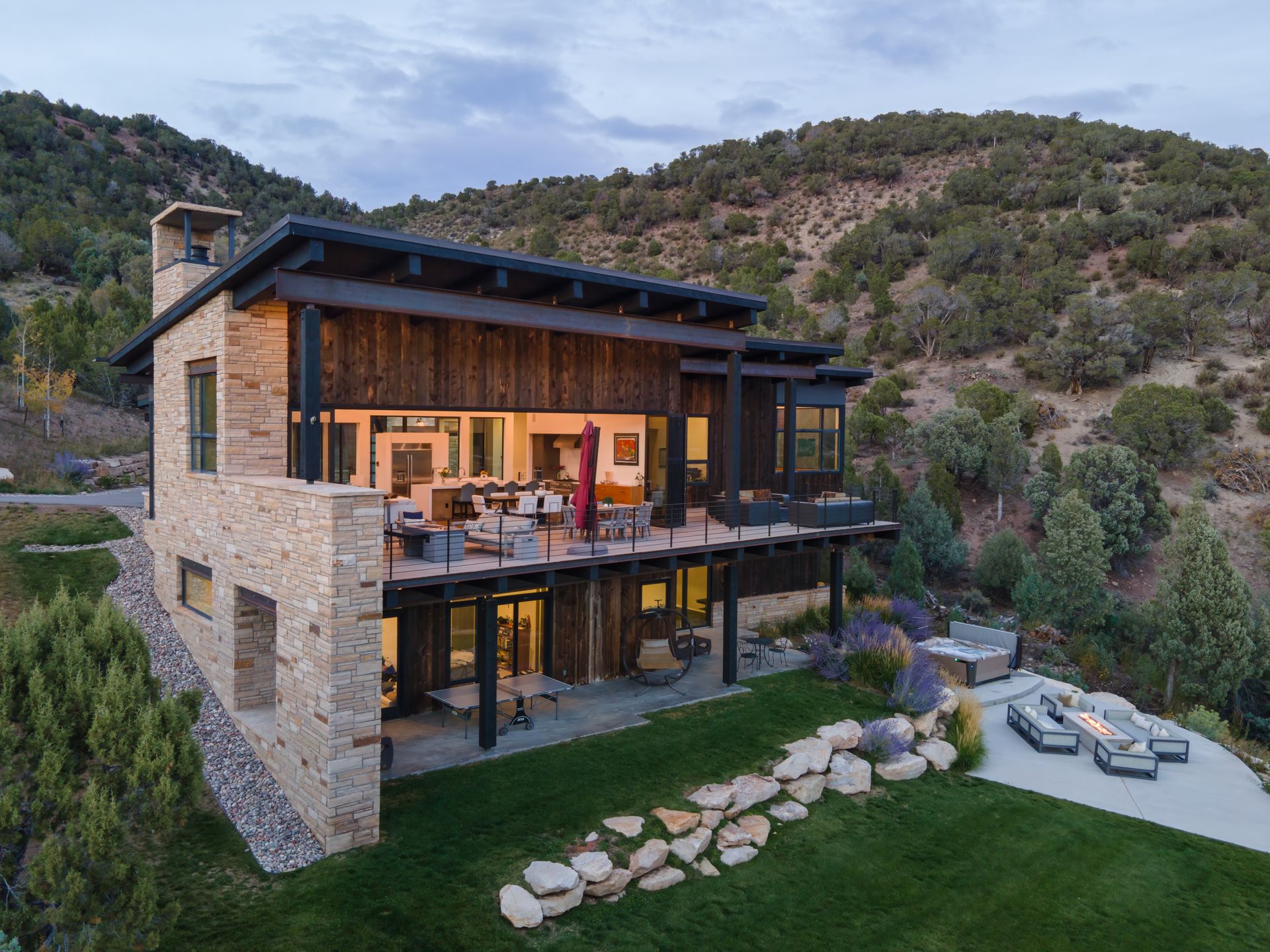 An aerial view of a large house sitting on top of a hill.