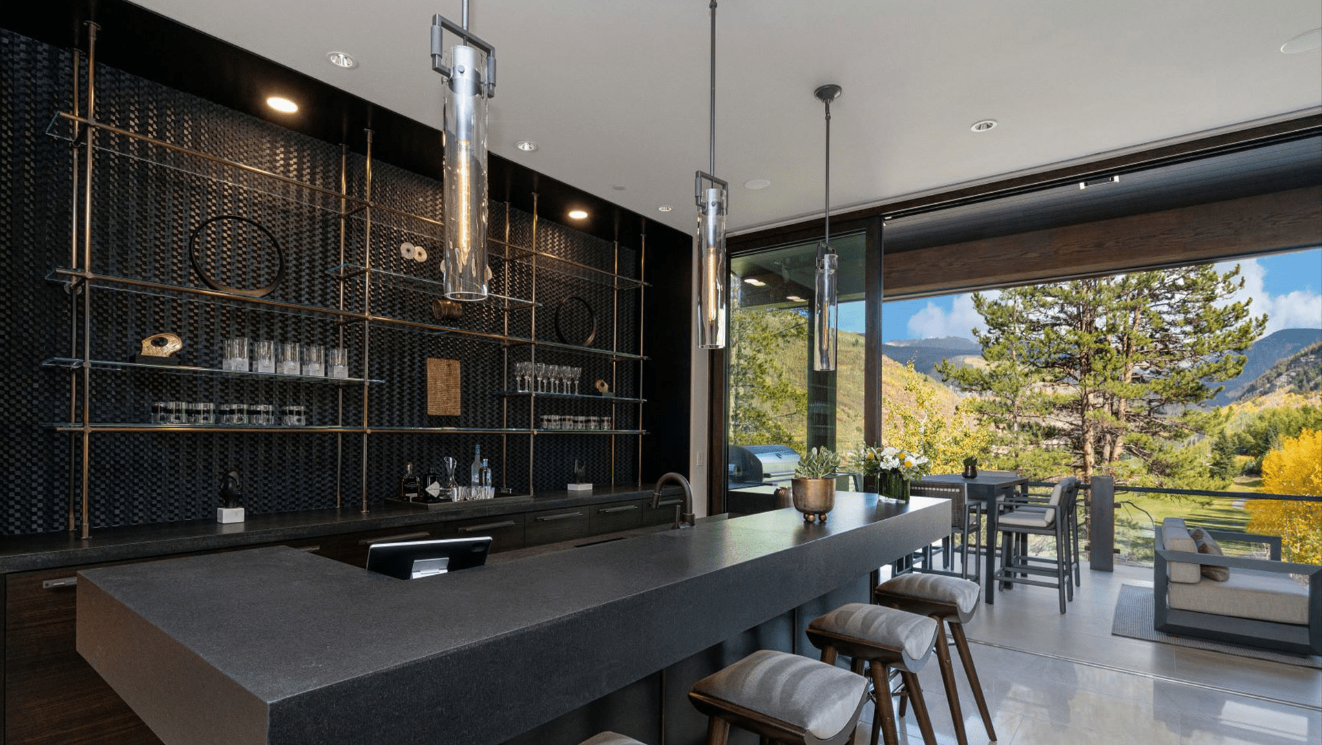 A modern kitchen with a large island and stools.