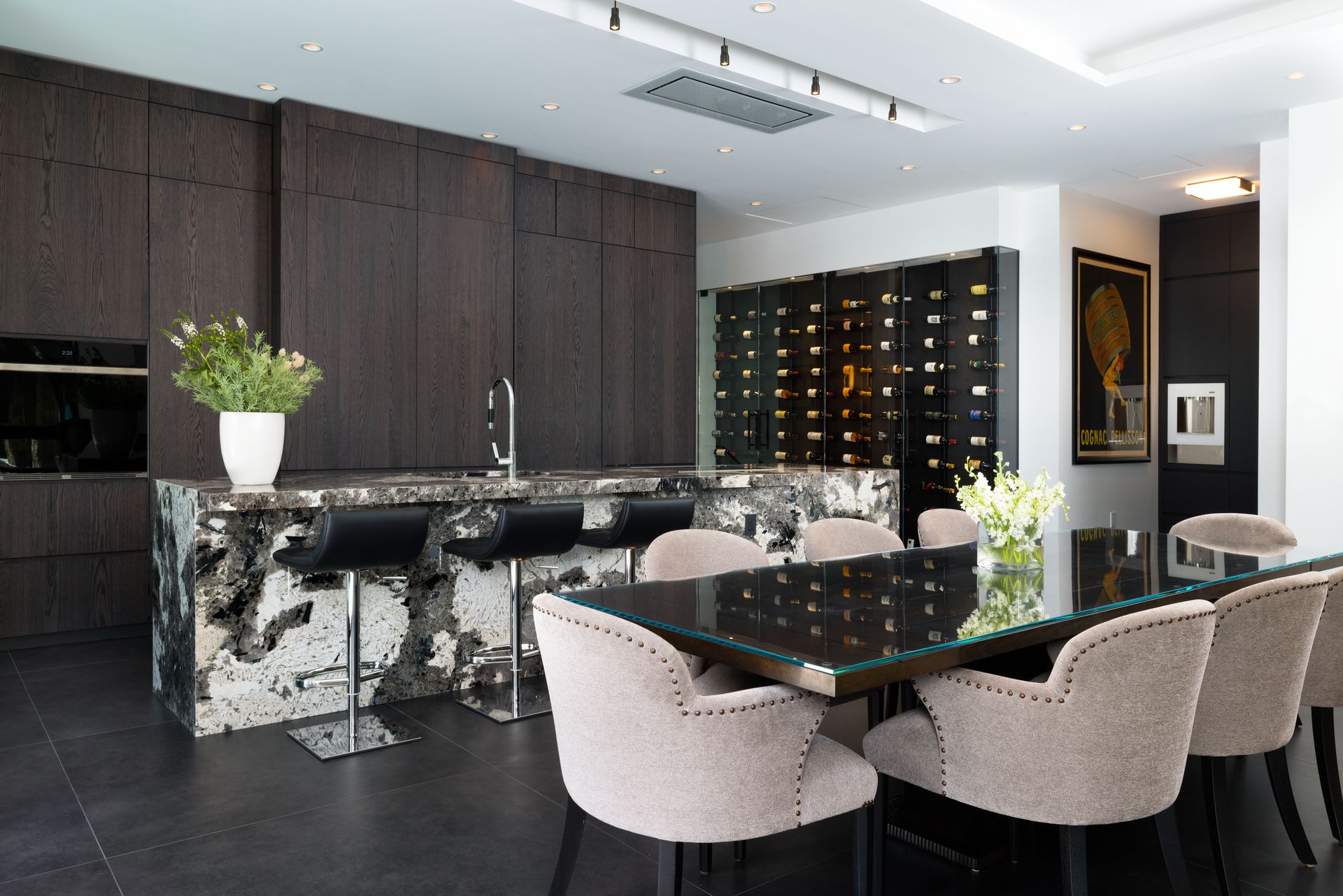 A living room with a dining table and chairs and a flat screen tv.