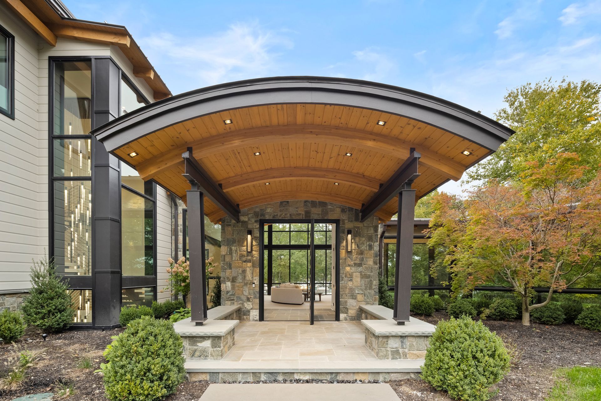 A large house with a wooden canopy over the entrance.