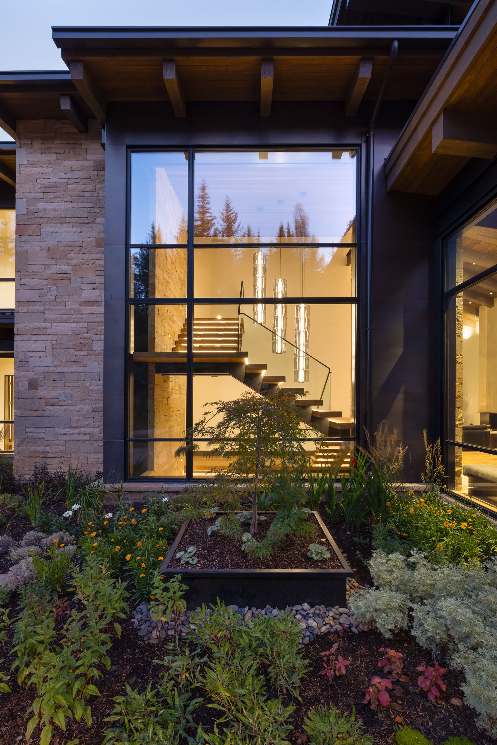 A large window on the side of a house with a staircase in the background.