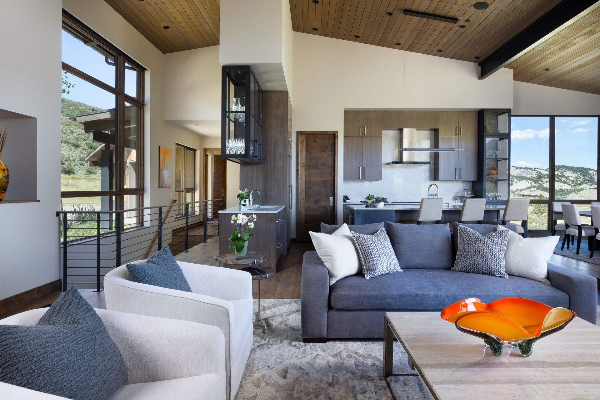 A living room with a couch and two chairs