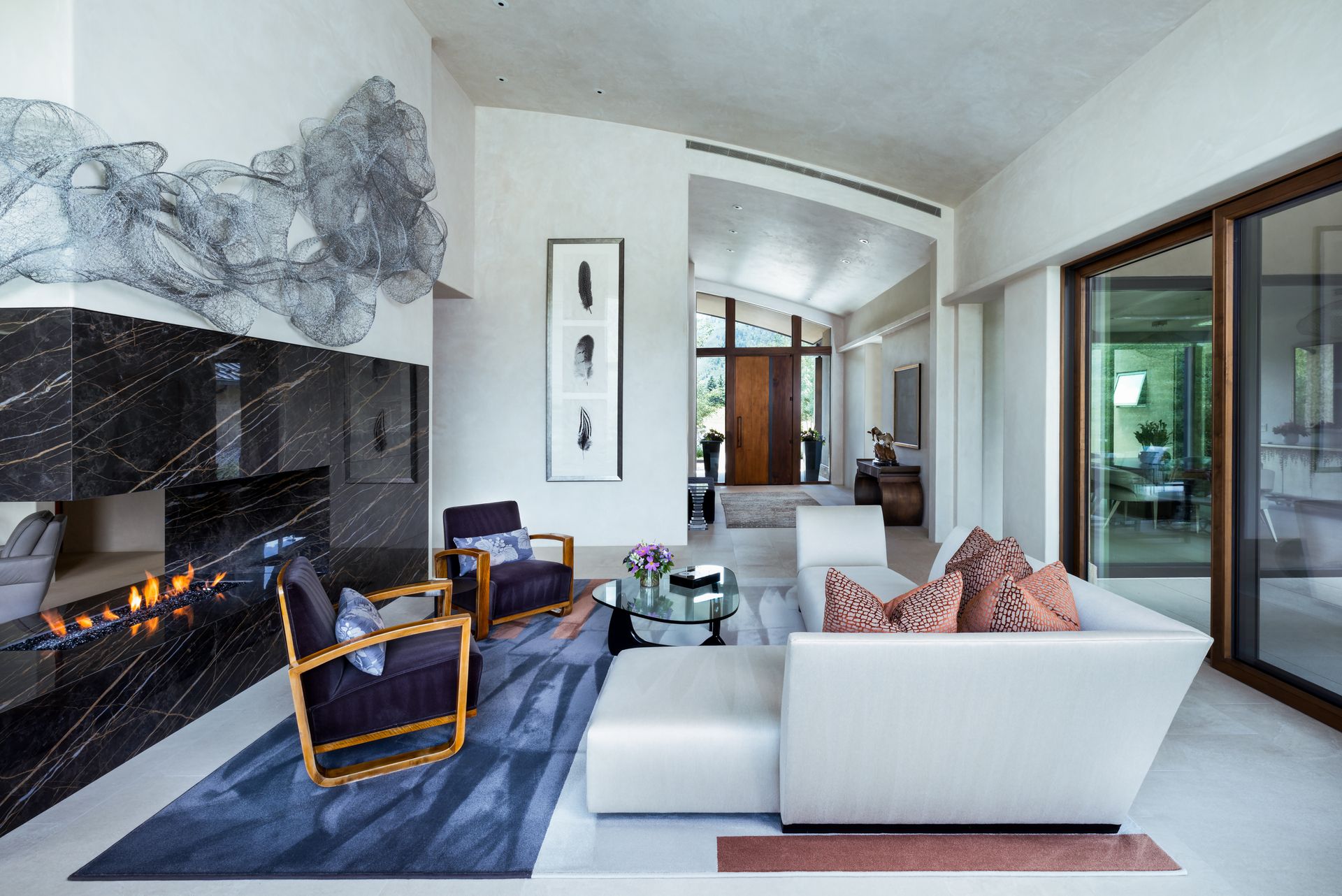 A living room with a couch and chairs and a fireplace