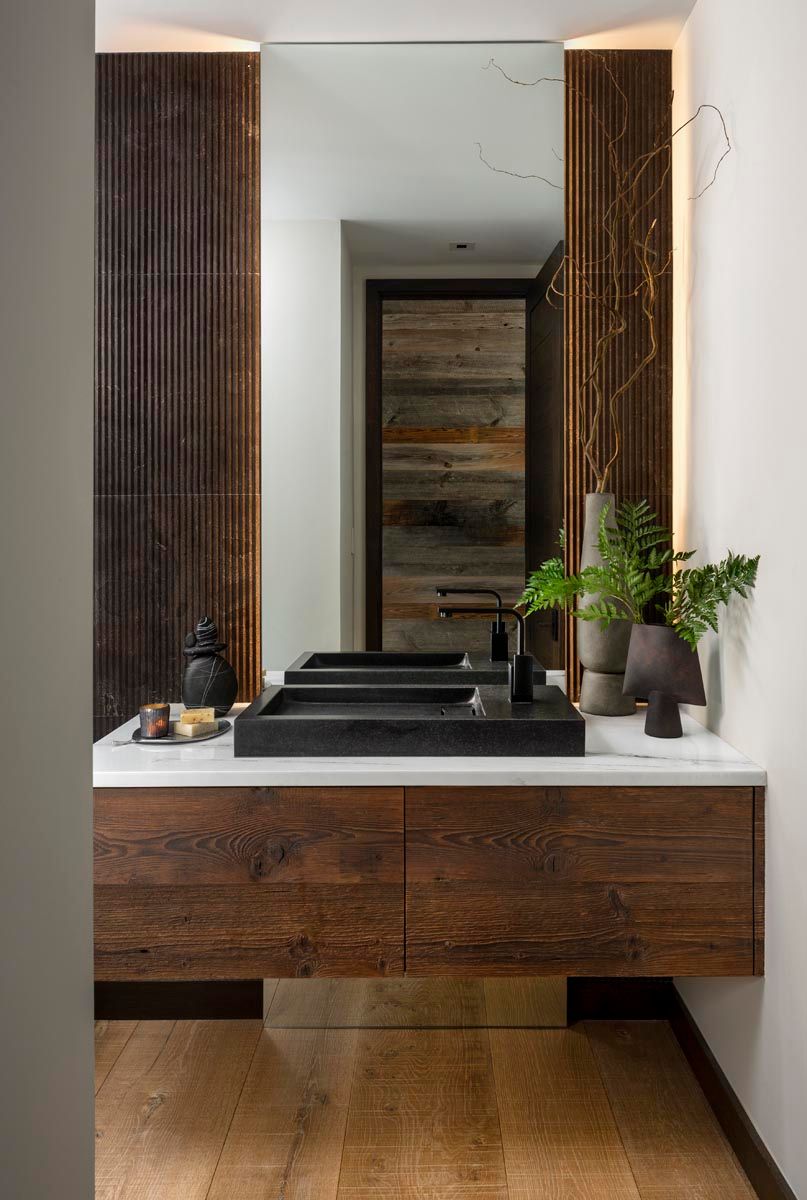 A bathroom with two sinks and a large mirror.