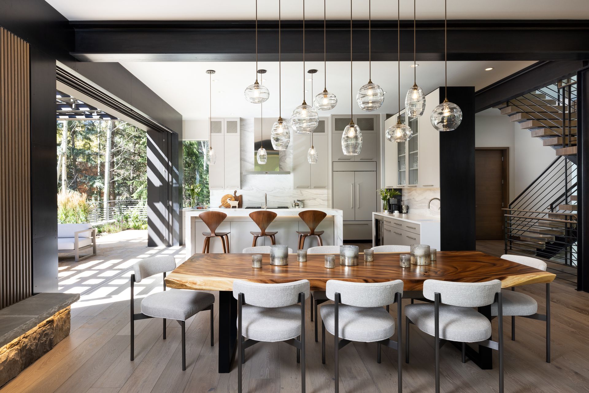 A dining room with a wooden table and white chairs