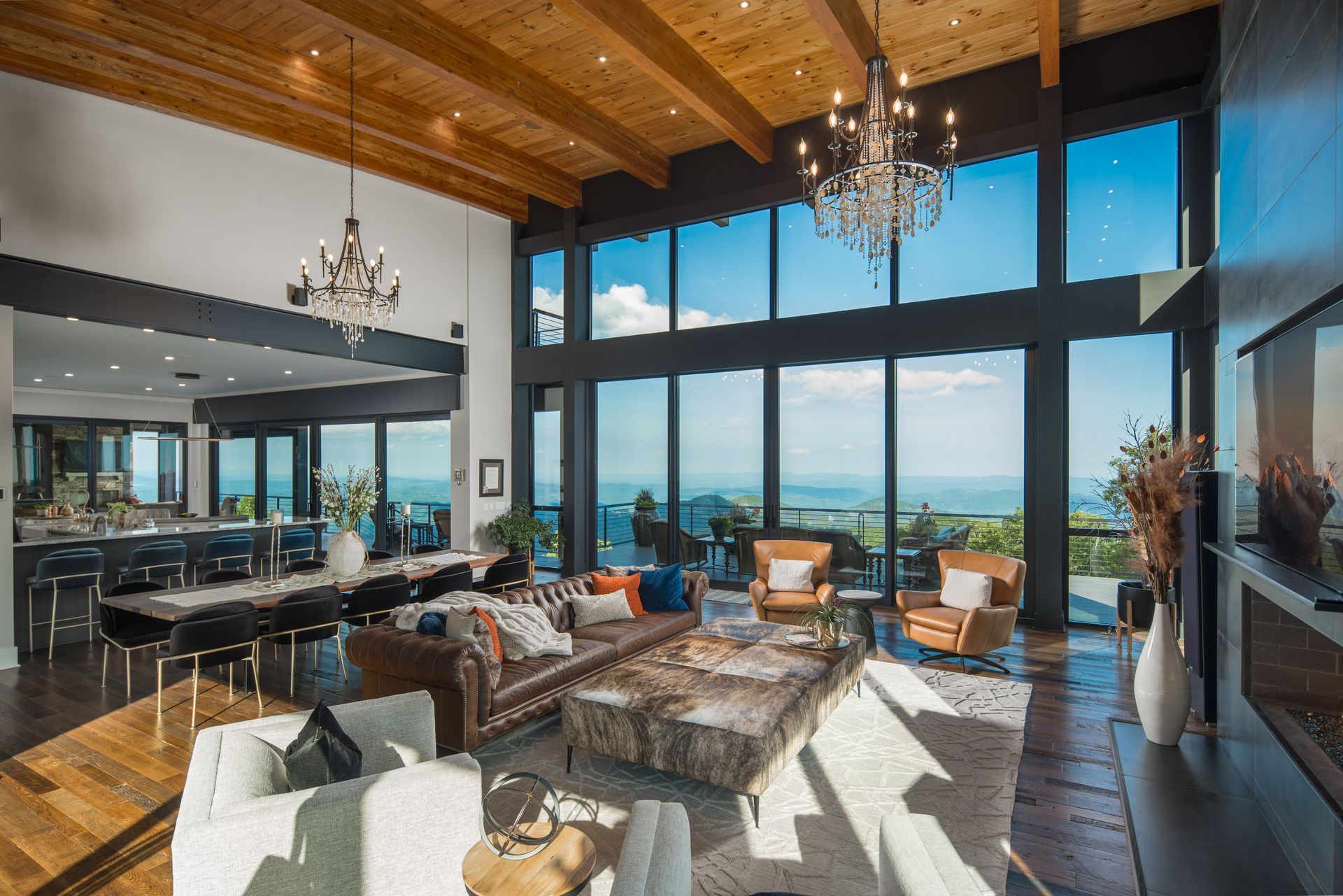 A living room with a lot of windows and a chandelier.