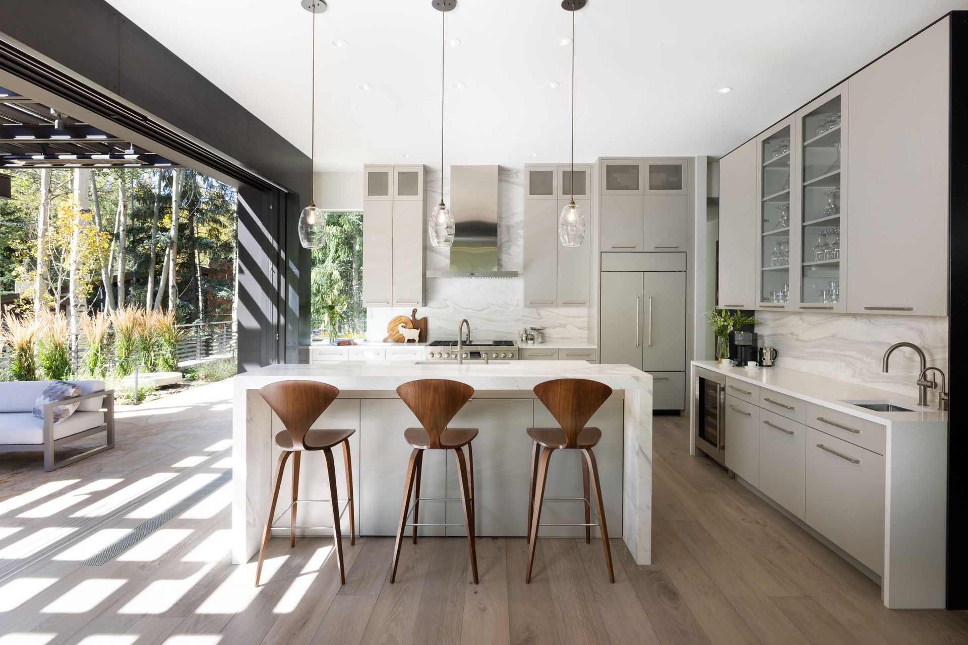 A kitchen with a large island and three stools