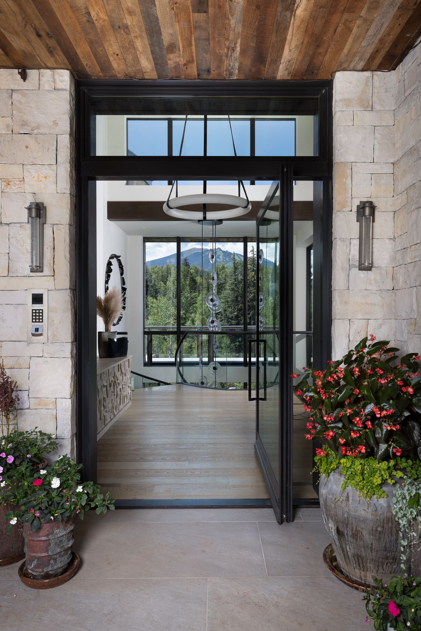 A house with a large glass door and a wooden ceiling
