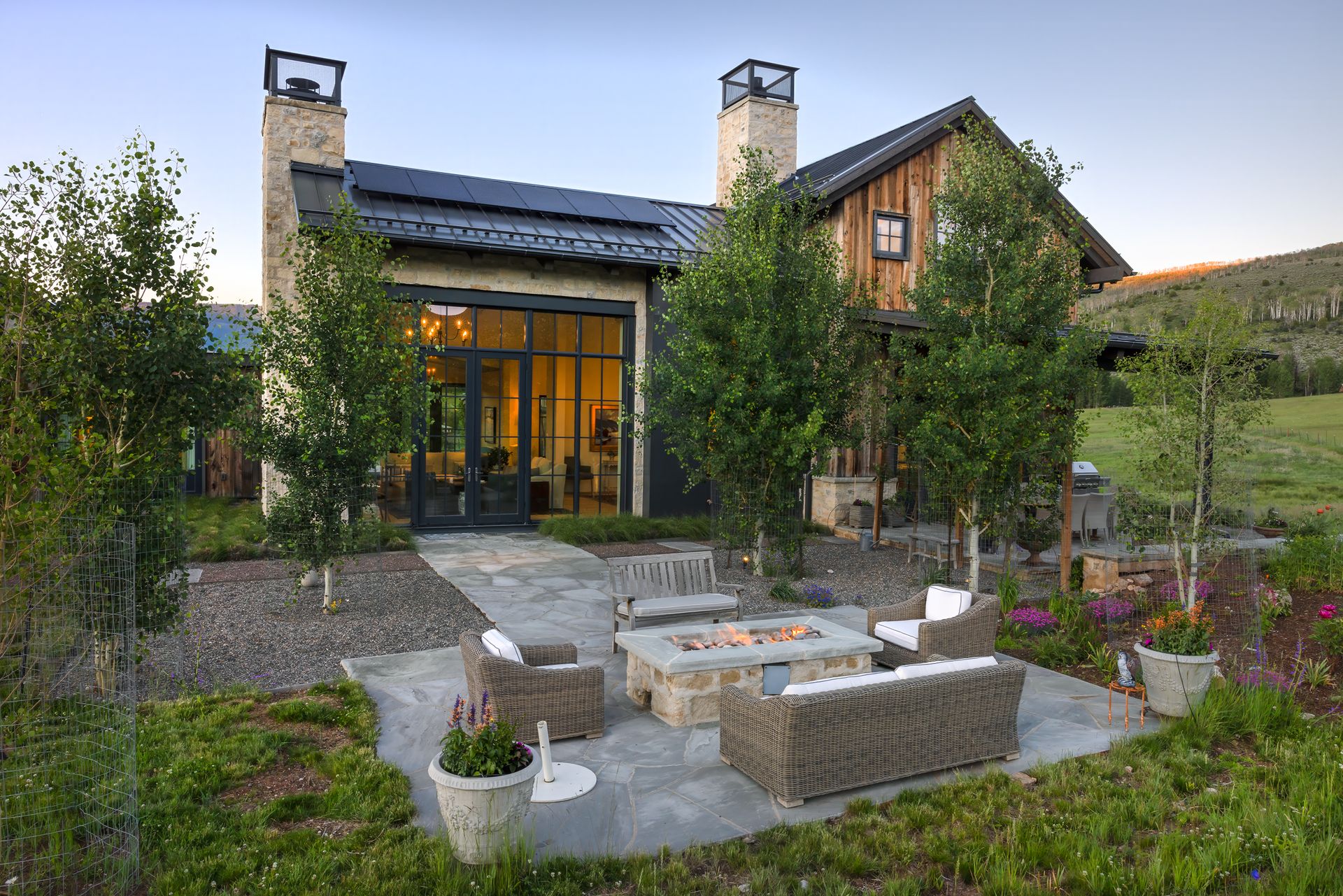 A large house with a patio area in front of it.