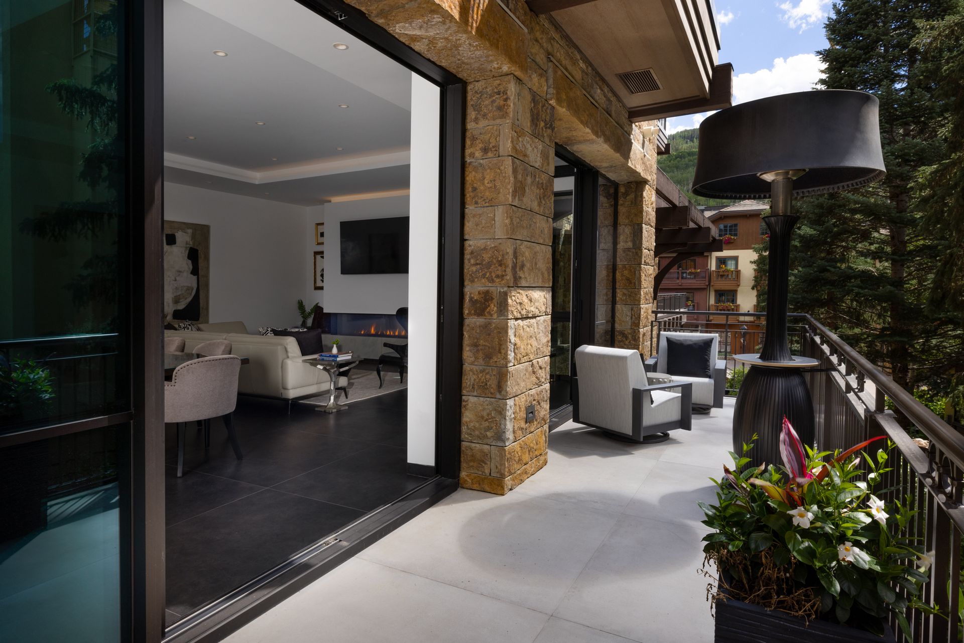 A balcony with sliding glass doors leading to a living room.