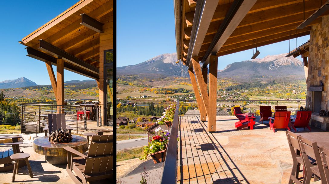 A patio with a view of mountains and a table and chairs.