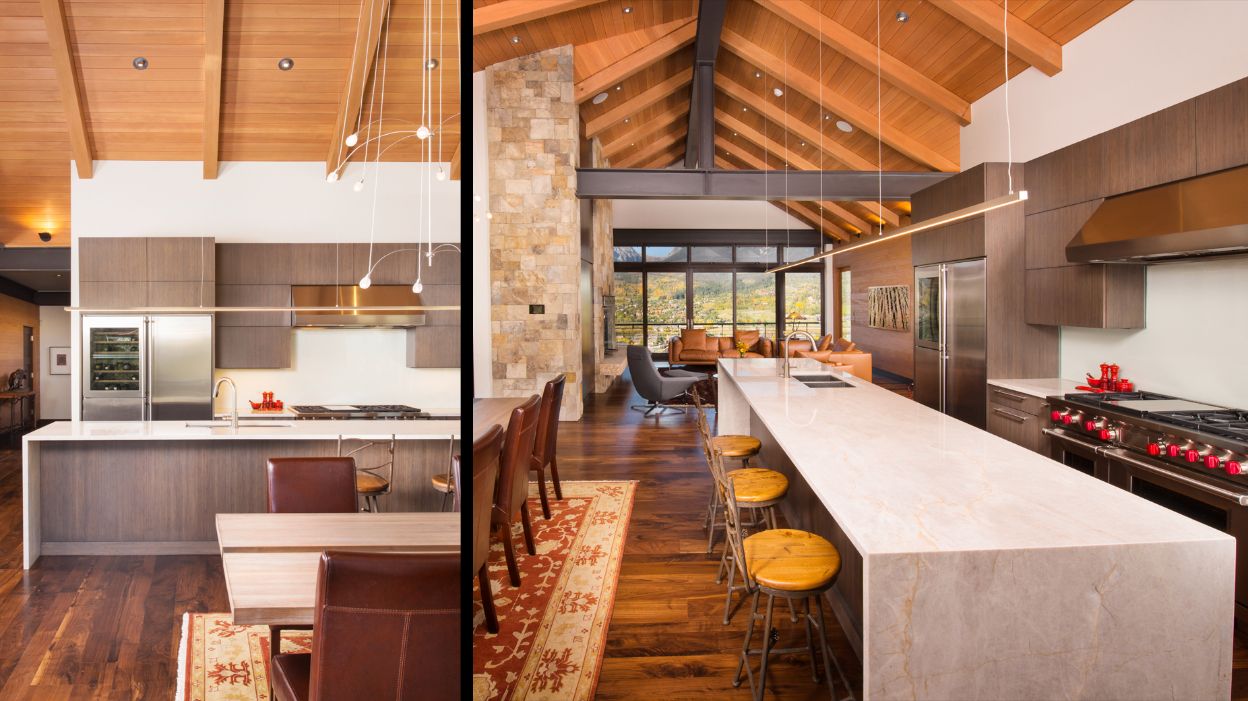 A kitchen with a long island and a stove in a house.