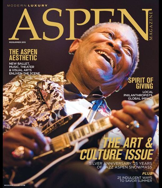 A man playing a guitar on the cover of aspen magazine