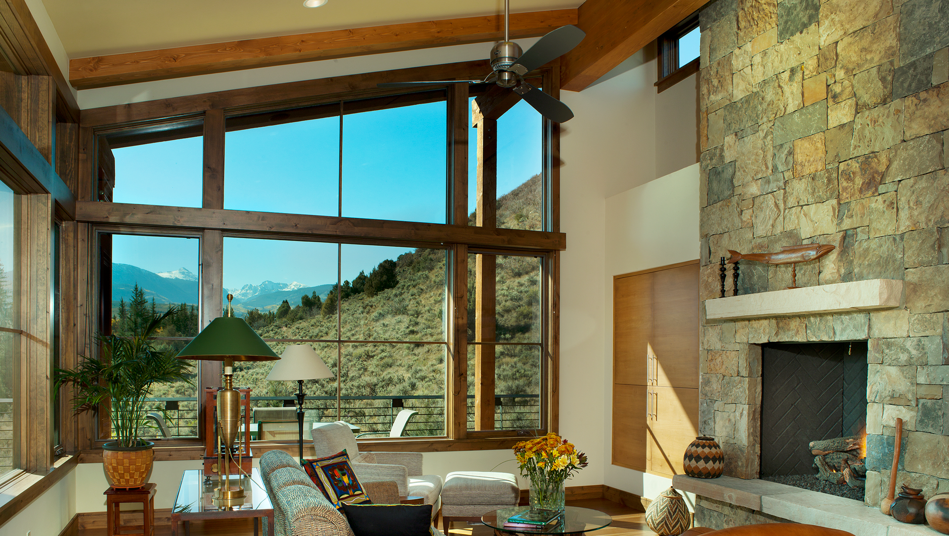 A living room with a fireplace and lots of windows