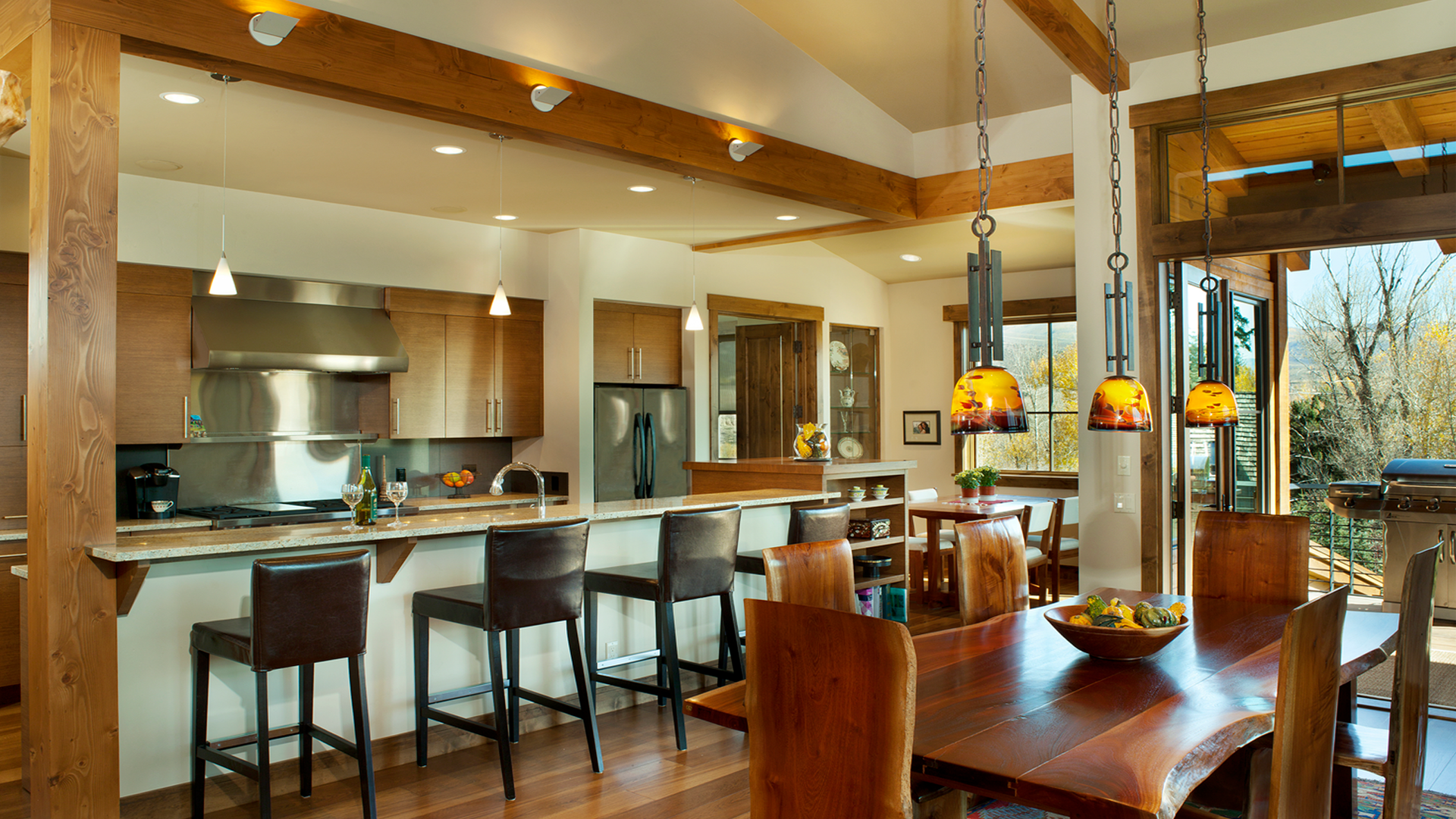 A kitchen and dining room in a house with a table and chairs