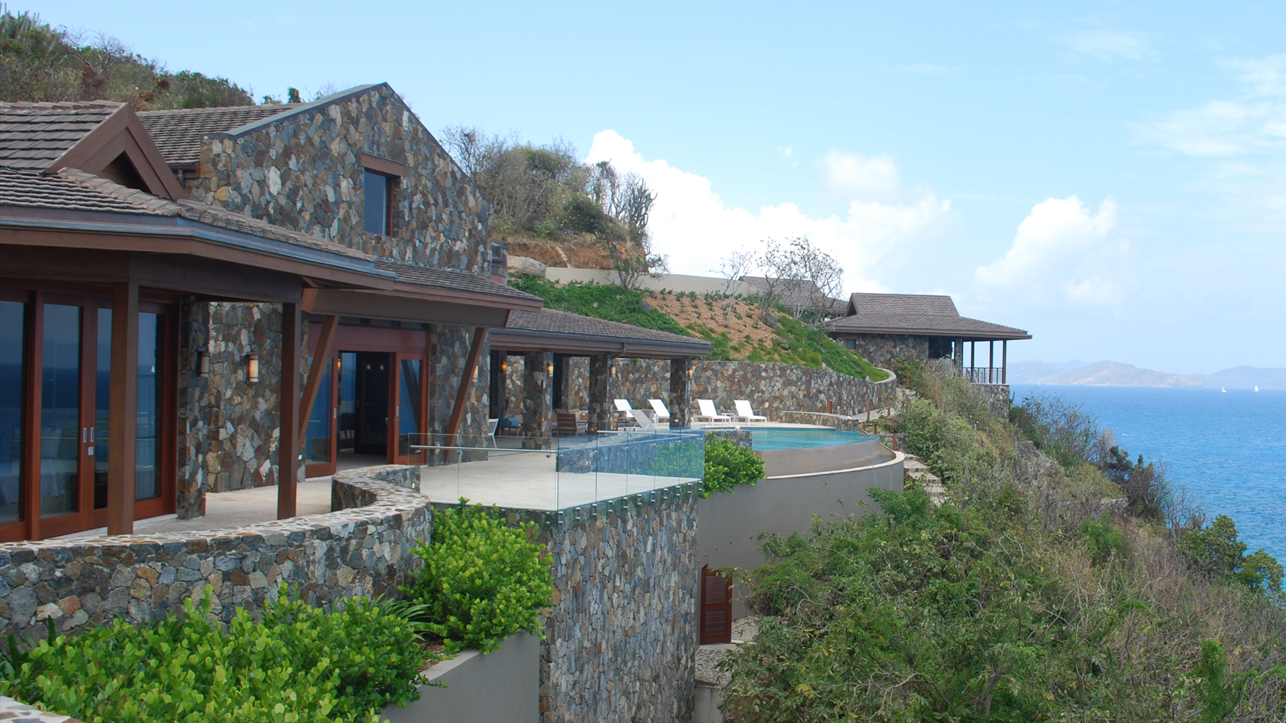 A large house on a cliff overlooking the ocean