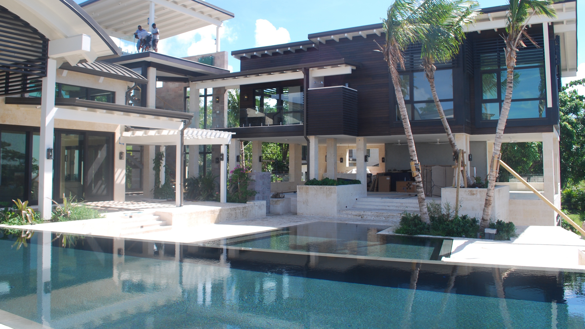 A large house with a swimming pool in front of it