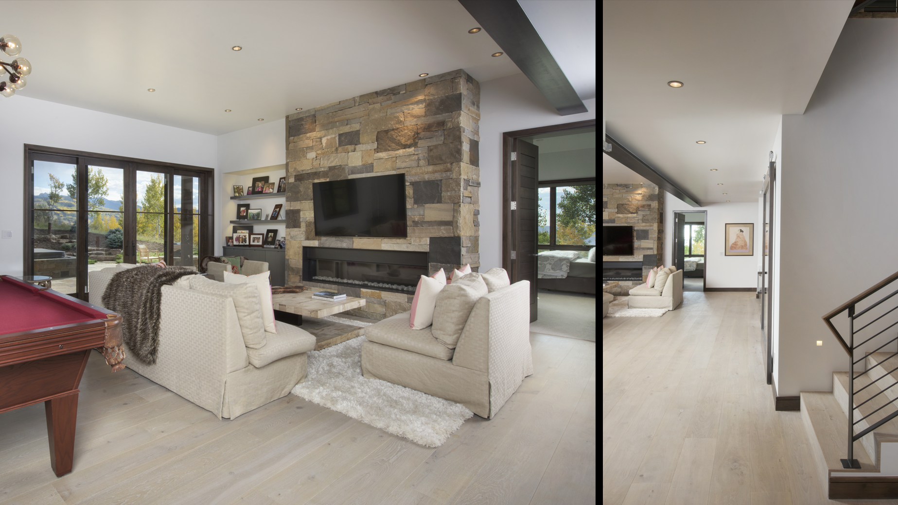 There is a pool table in the middle of the living room.