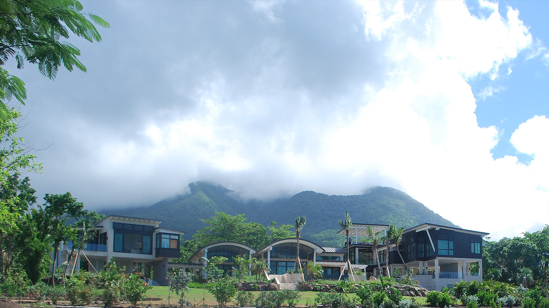 A row of houses with a mountain in the background