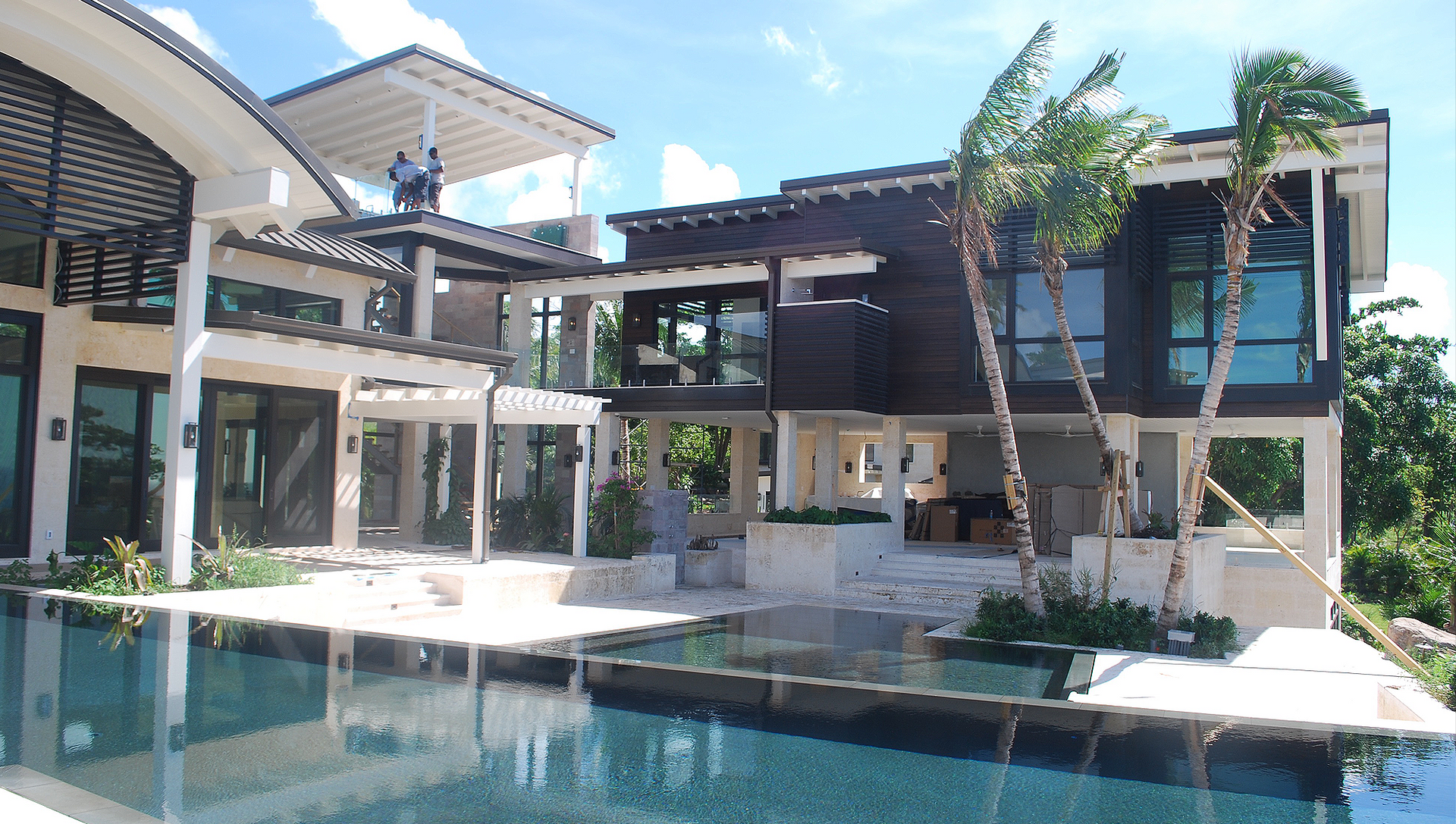 A large house with a swimming pool in front of it