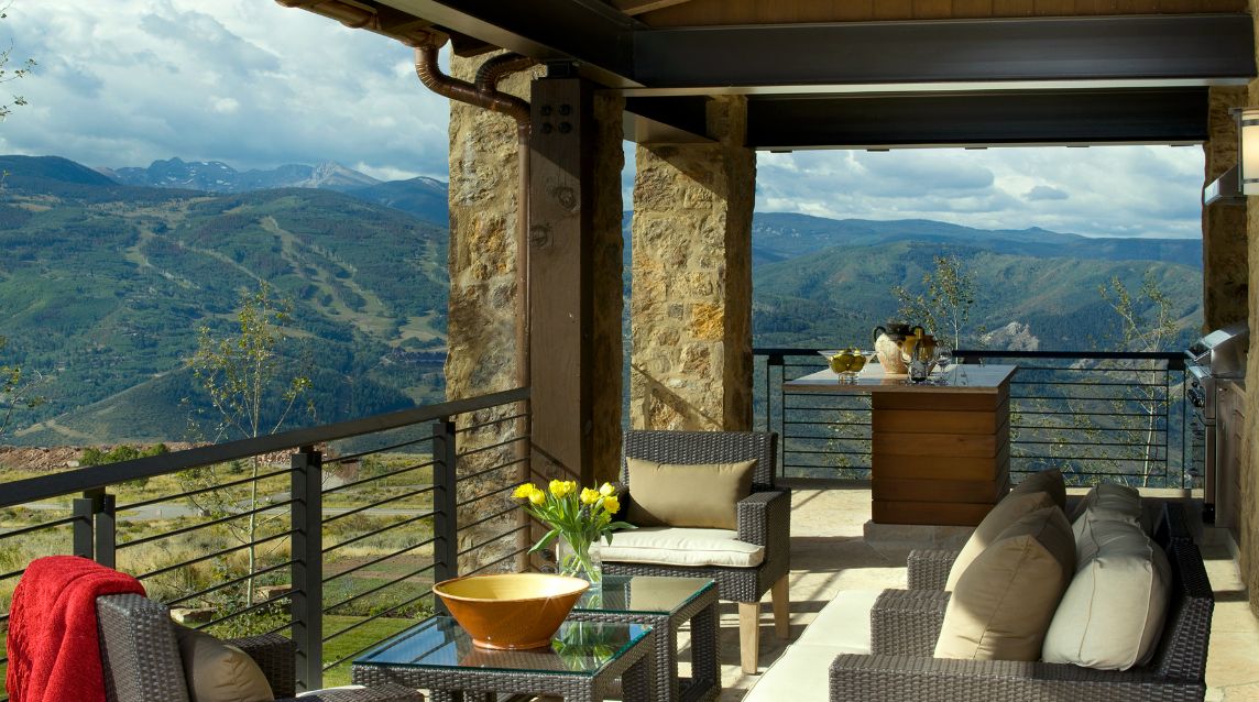 There is a balcony with a view of the mountains.