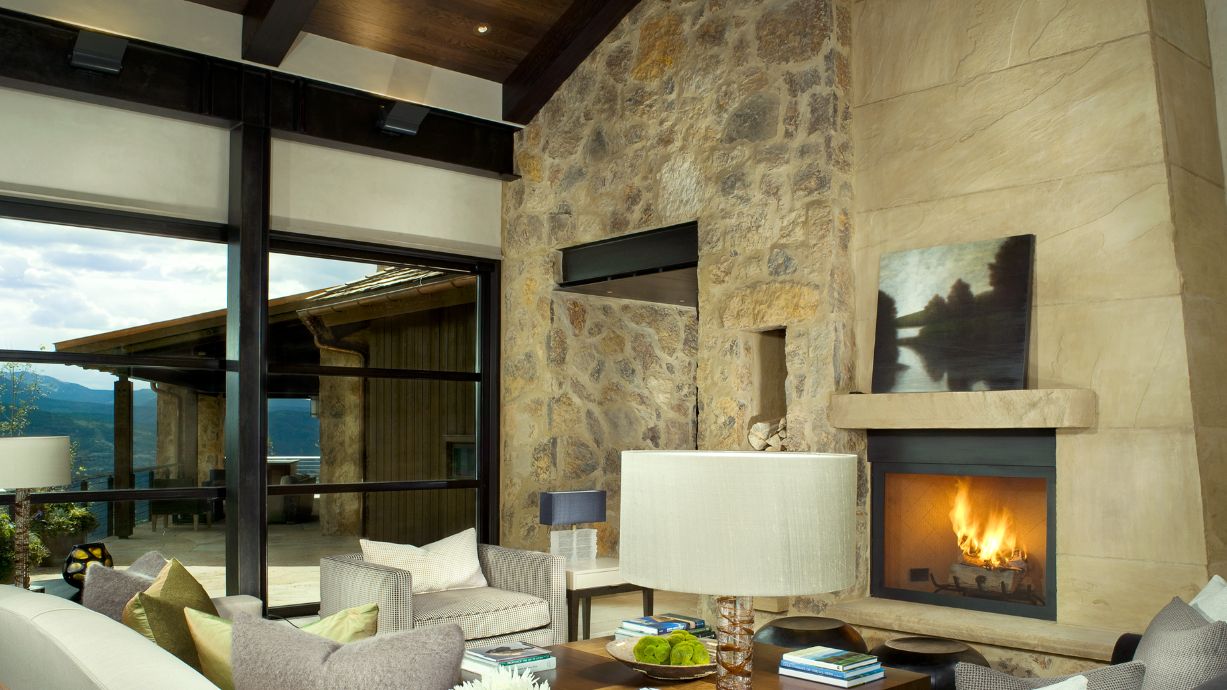 A living room with a fireplace and a lot of windows