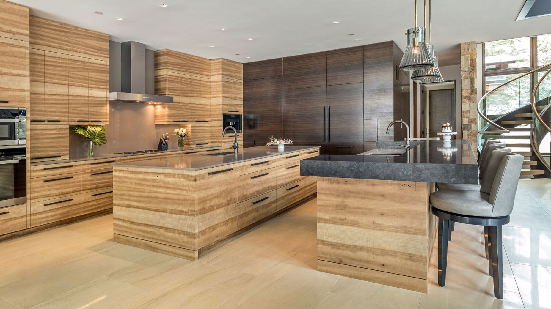 A kitchen with wooden cabinets and a large island in the middle.