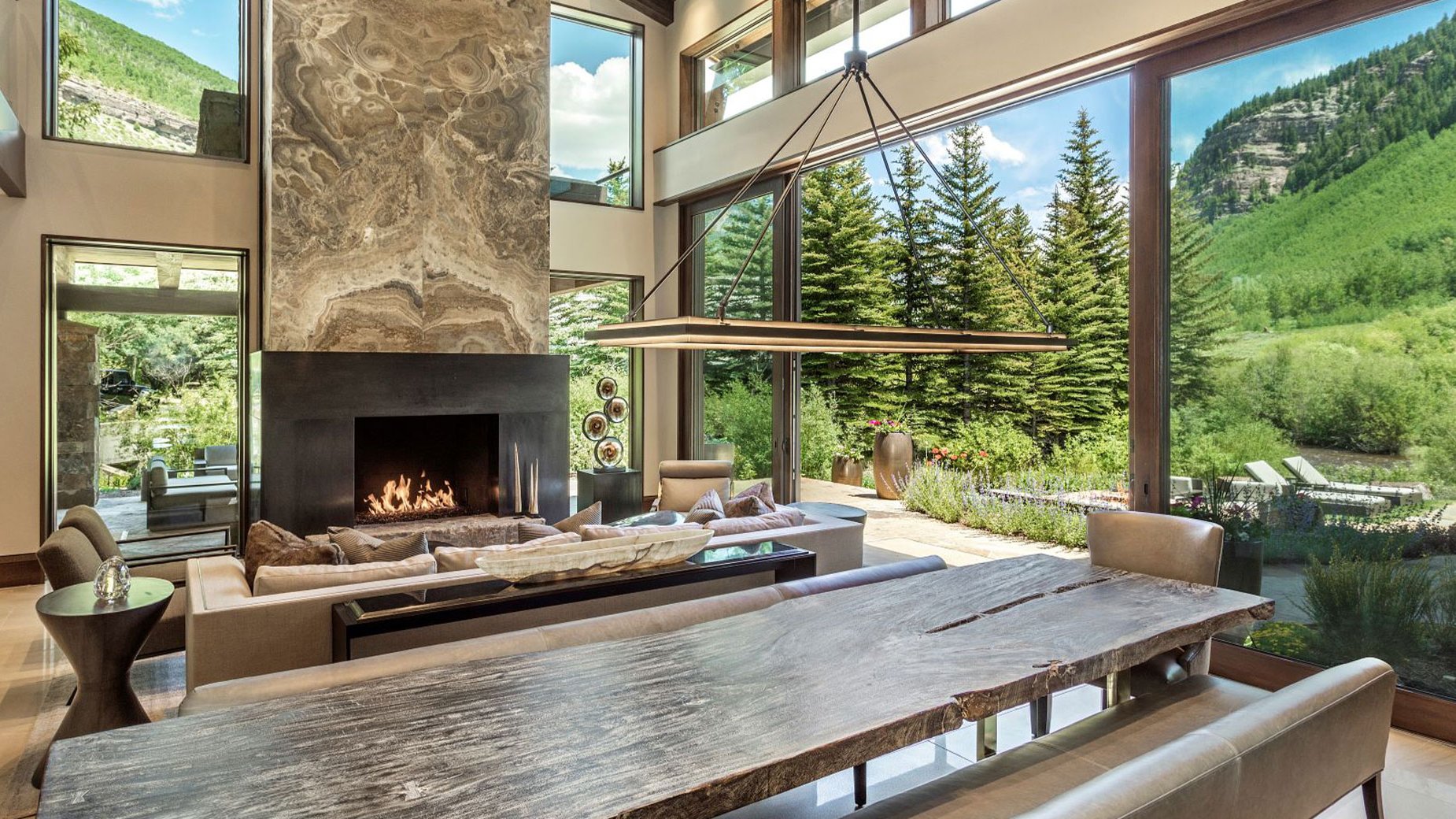 A living room with a fireplace and a large table.