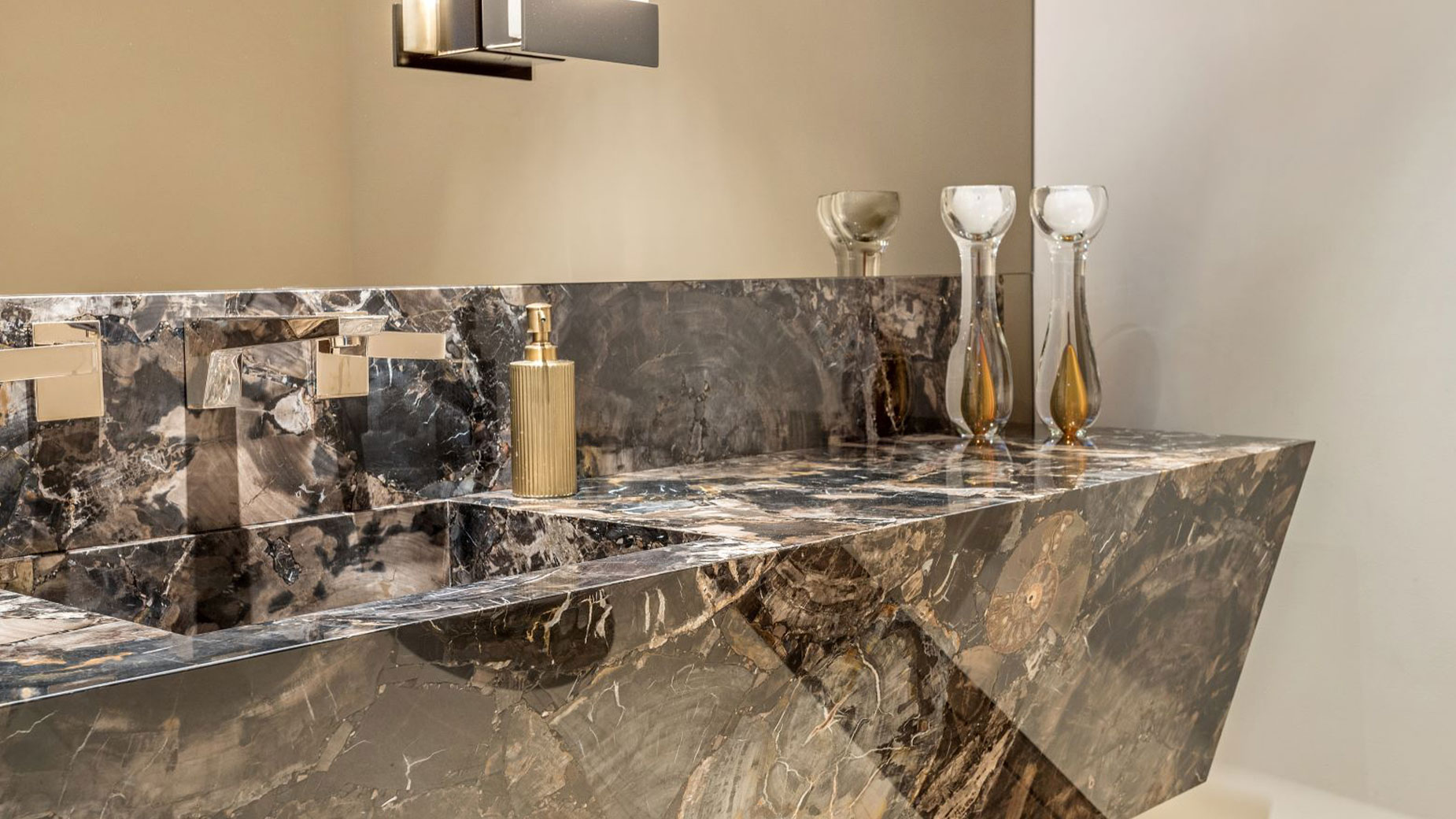 A bathroom with a marble sink and a mirror.