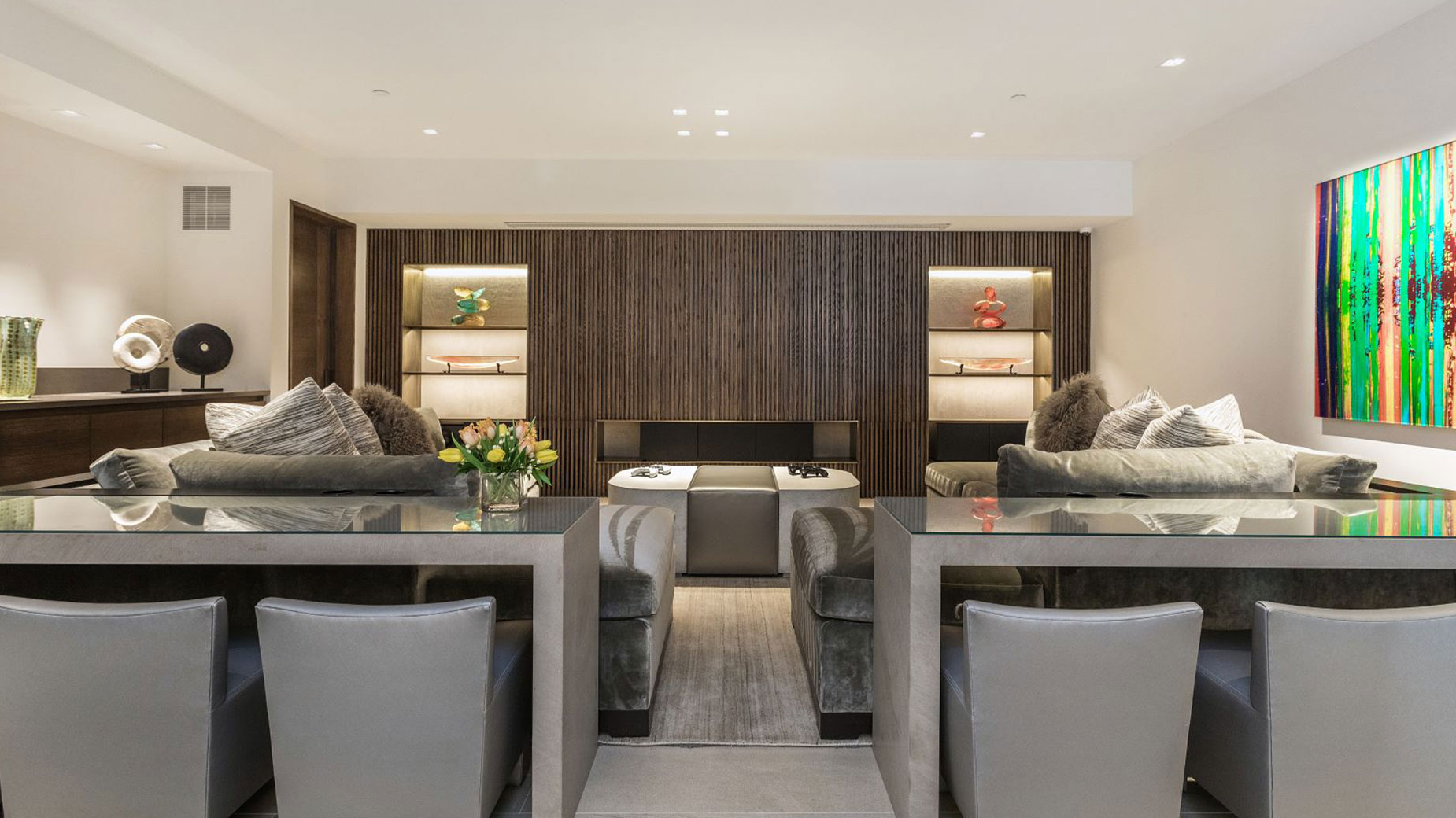 A living room with a couch , chairs , a table and a fireplace.