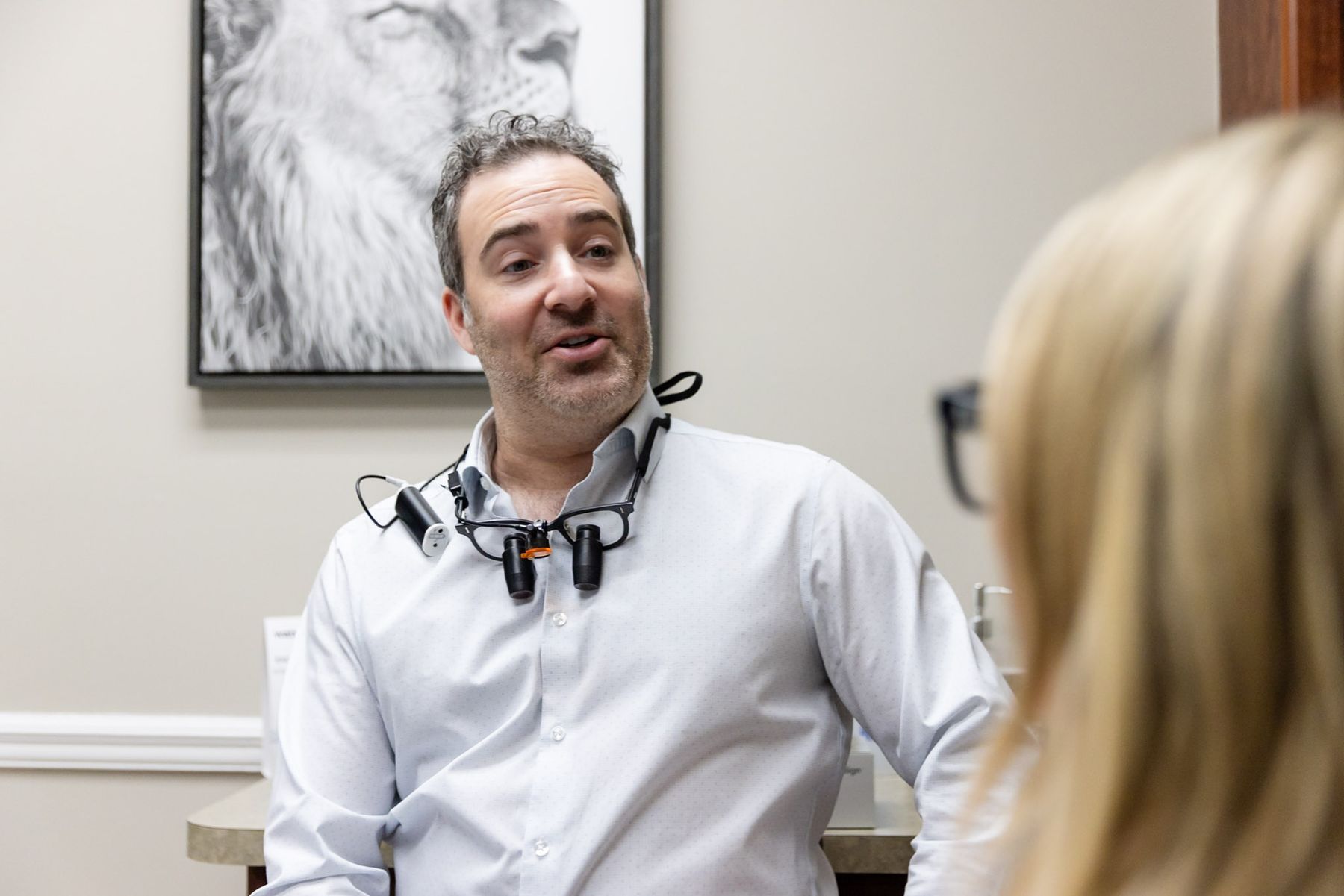 Dentist talking with a patient during a consultation, photographed by Digital Floss