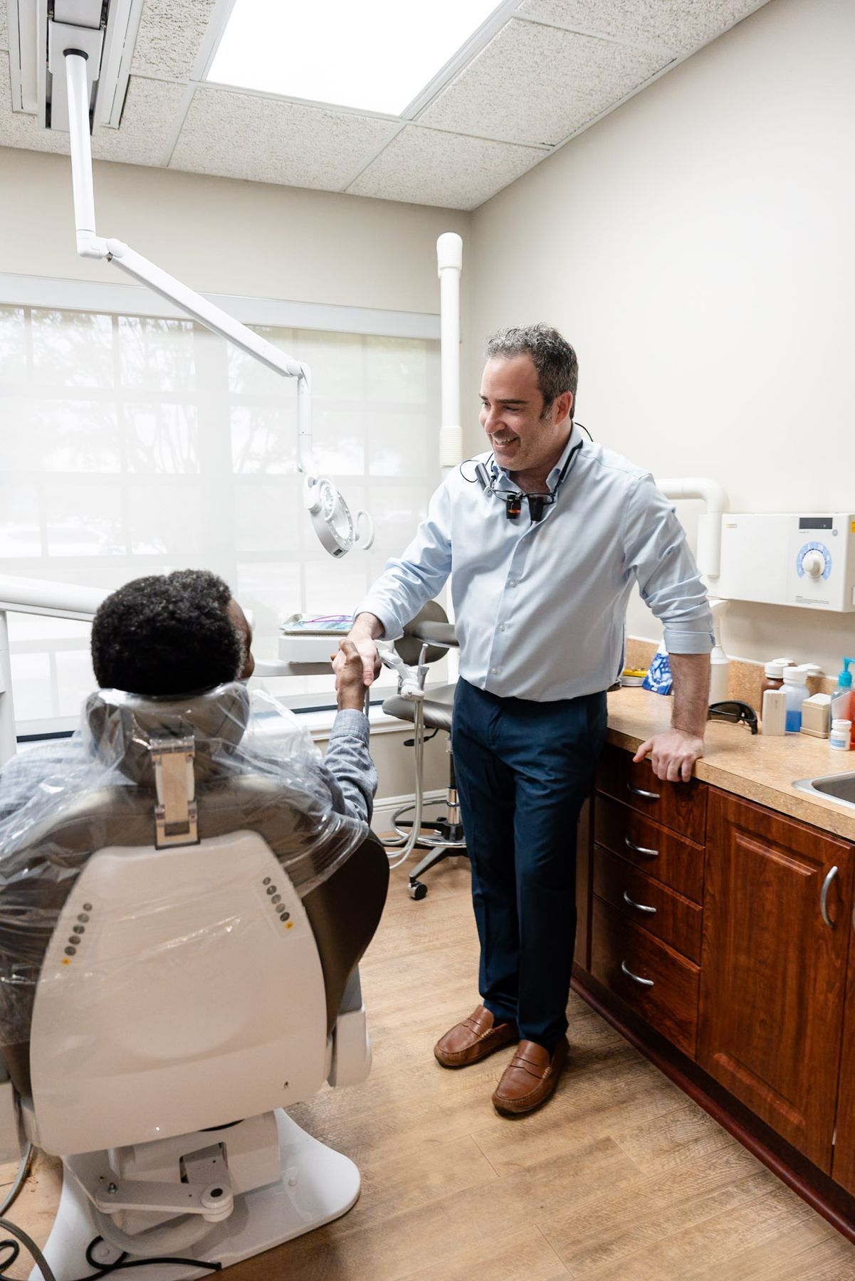Dentist at My Pompano Dentist greeting a patient in the operatory