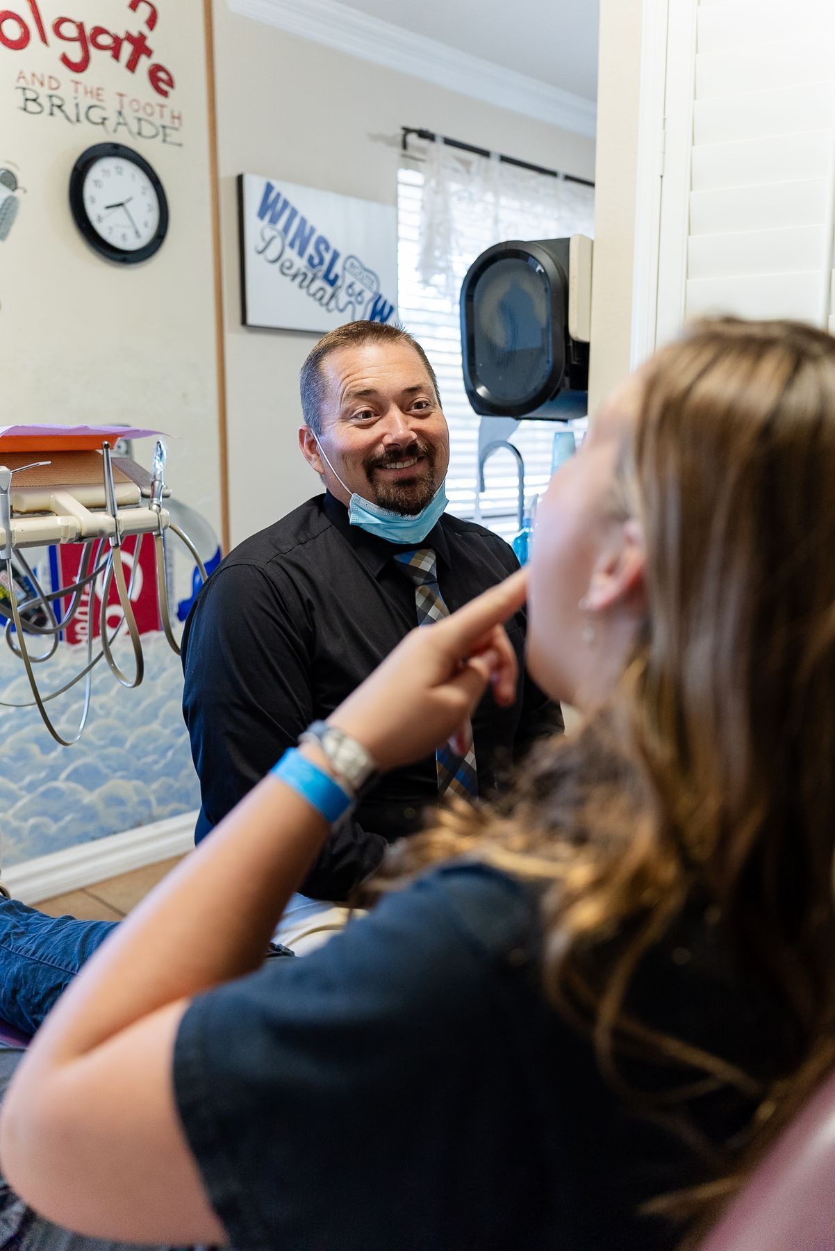 Dentist at Winslow Dental laughing with a patient in the operatory