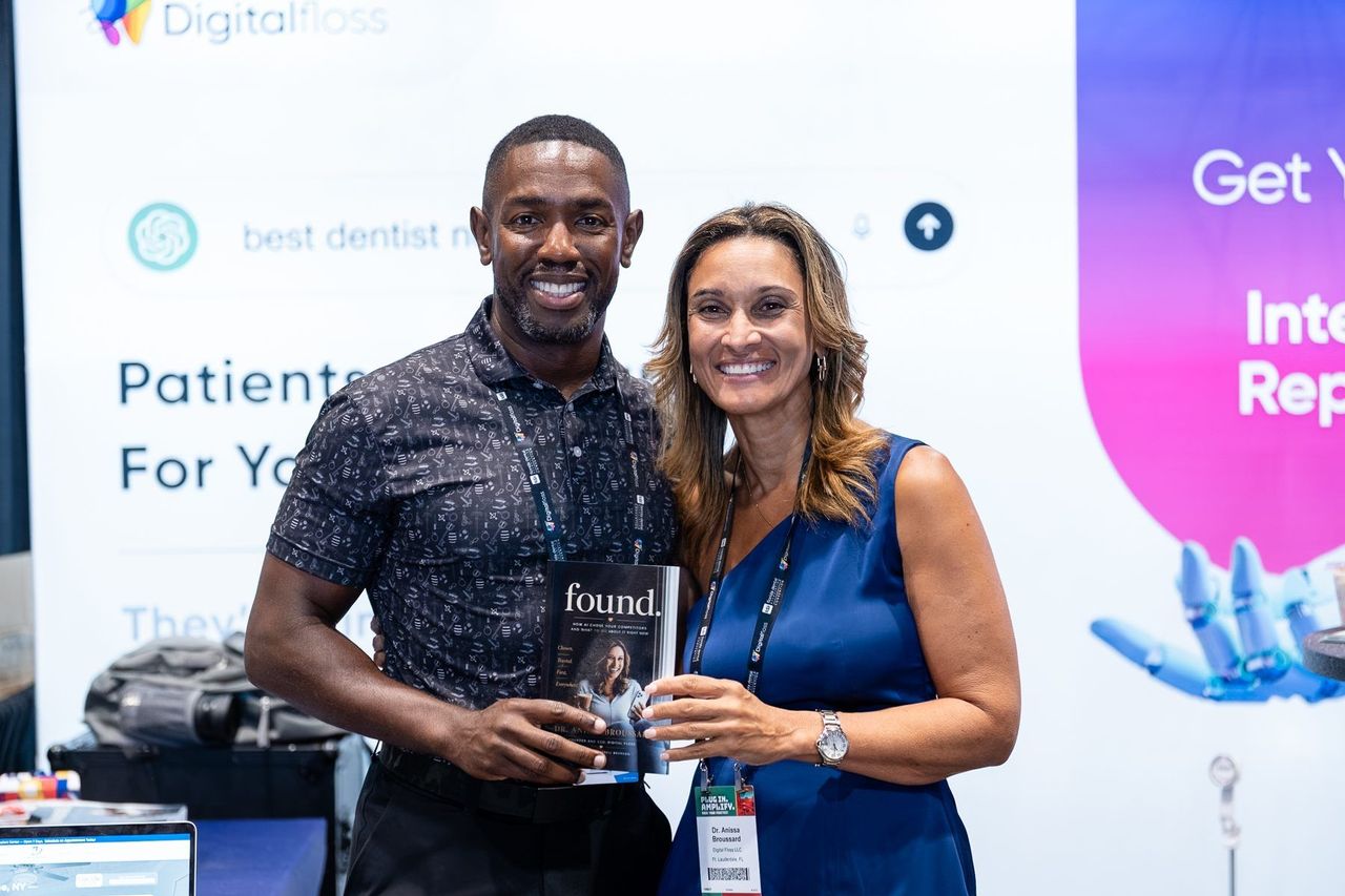 Dr. Anissa Broussard with an attendee holding FOUND in front of the Digital Floss booth backdrop, Florida Dental Convention 2026