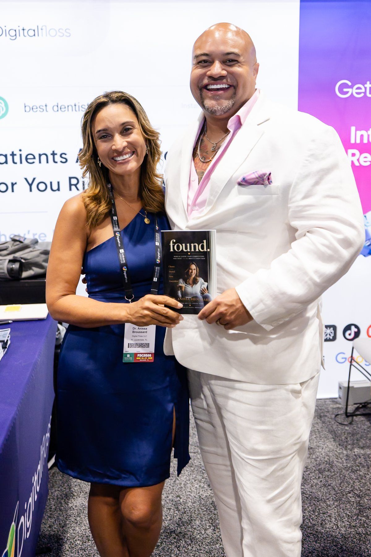 Dr. Anissa Broussard and Elijah Desmond holding FOUND together at the Digital Floss booth, Florida Dental Convention 2026