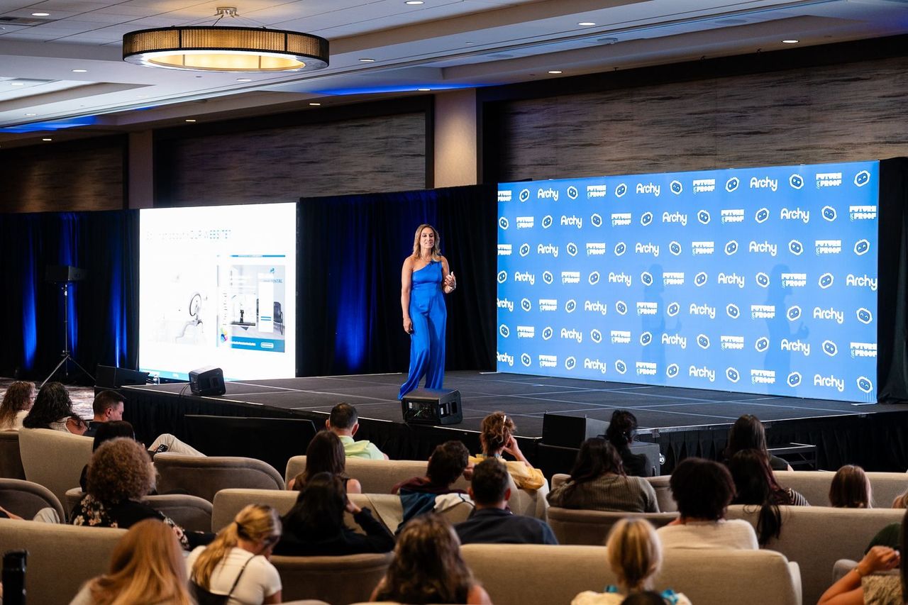 Dr. Anissa Broussard speaking on the Archy FutureProof stage to a full ballroom