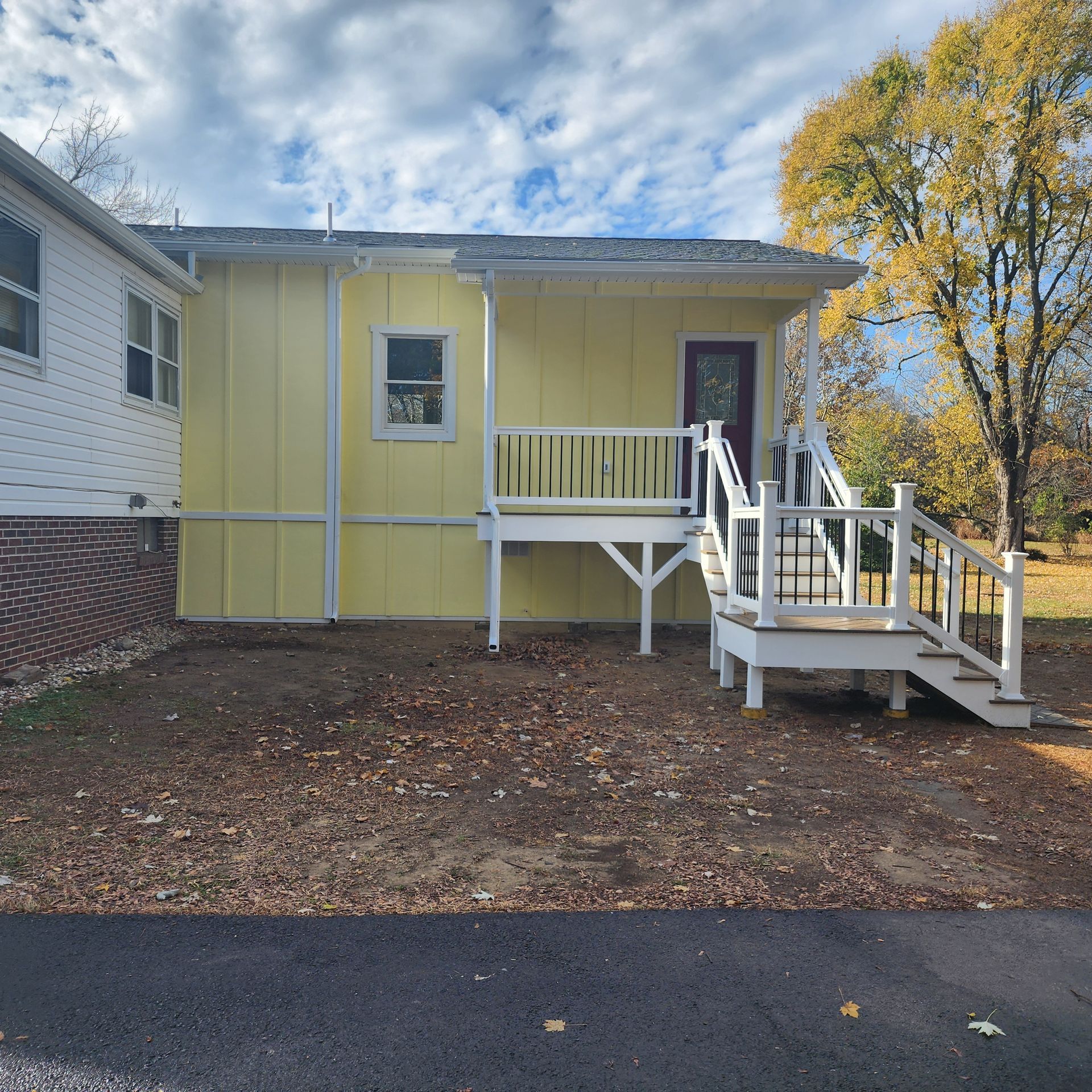 Yellow House with White Deck — Newark, DE — Oakes Signature Homes