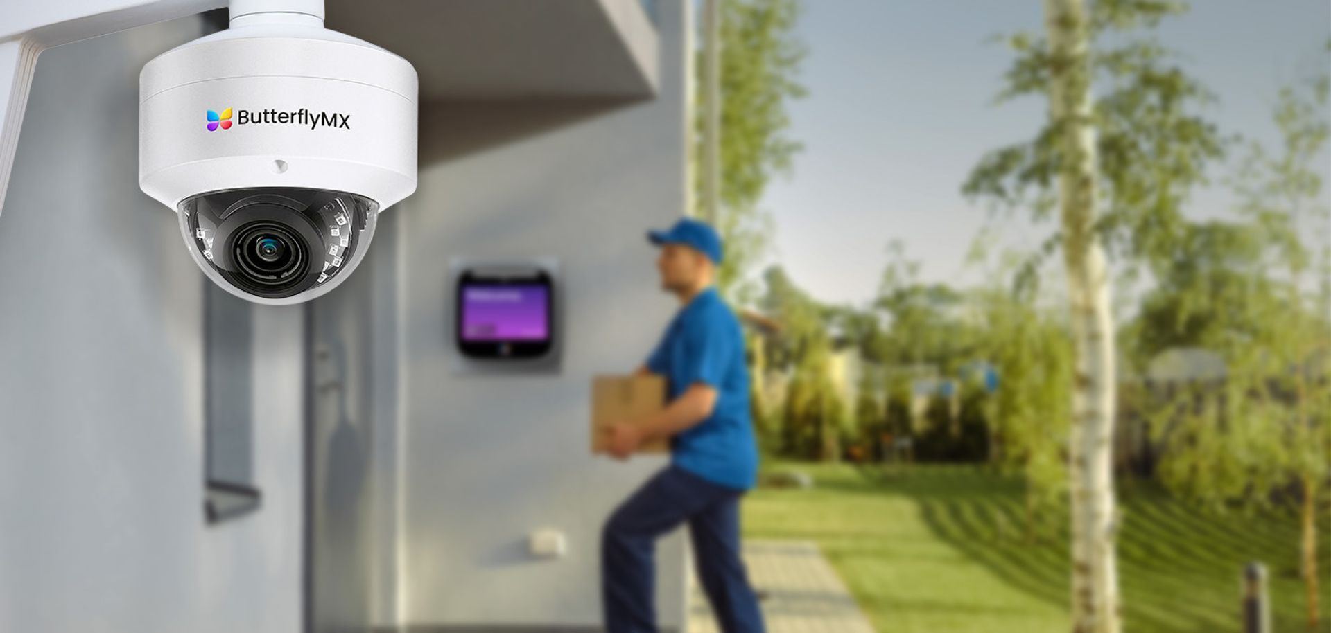 A security dome camera mounted to a wall overlooking an entryway as a delivery person carrying a box walks by.
