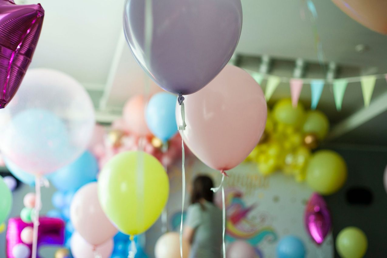 Palloncini colorati e festoni in una luminosa sala per feste al coperto.