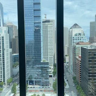View through a window of tall city skyscrapers on a cloudy day