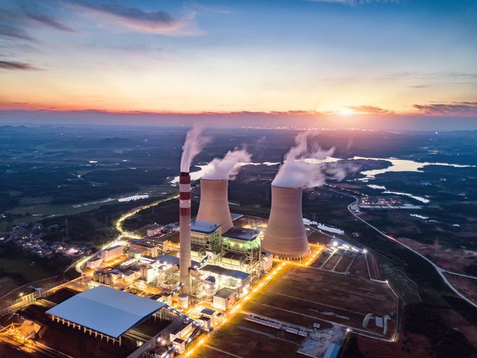 An aerial view of a nuclear power plant at sunset.